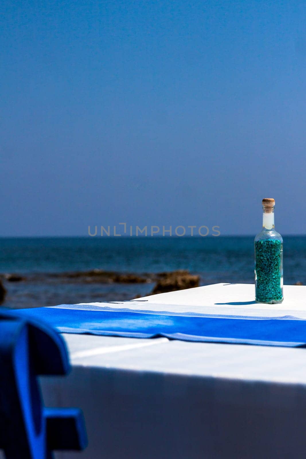 Tables with chairs in traditional Greek tavern in Kolympia town on coast of Rhodes island, Greece.