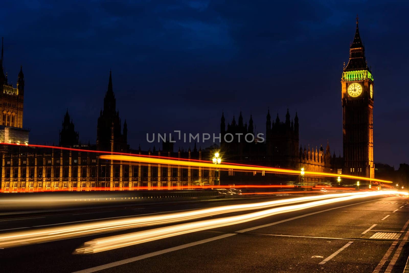 Light trail in the night at Big Ben Clock Tower and House of Parliament, London, England, UK, selective focus