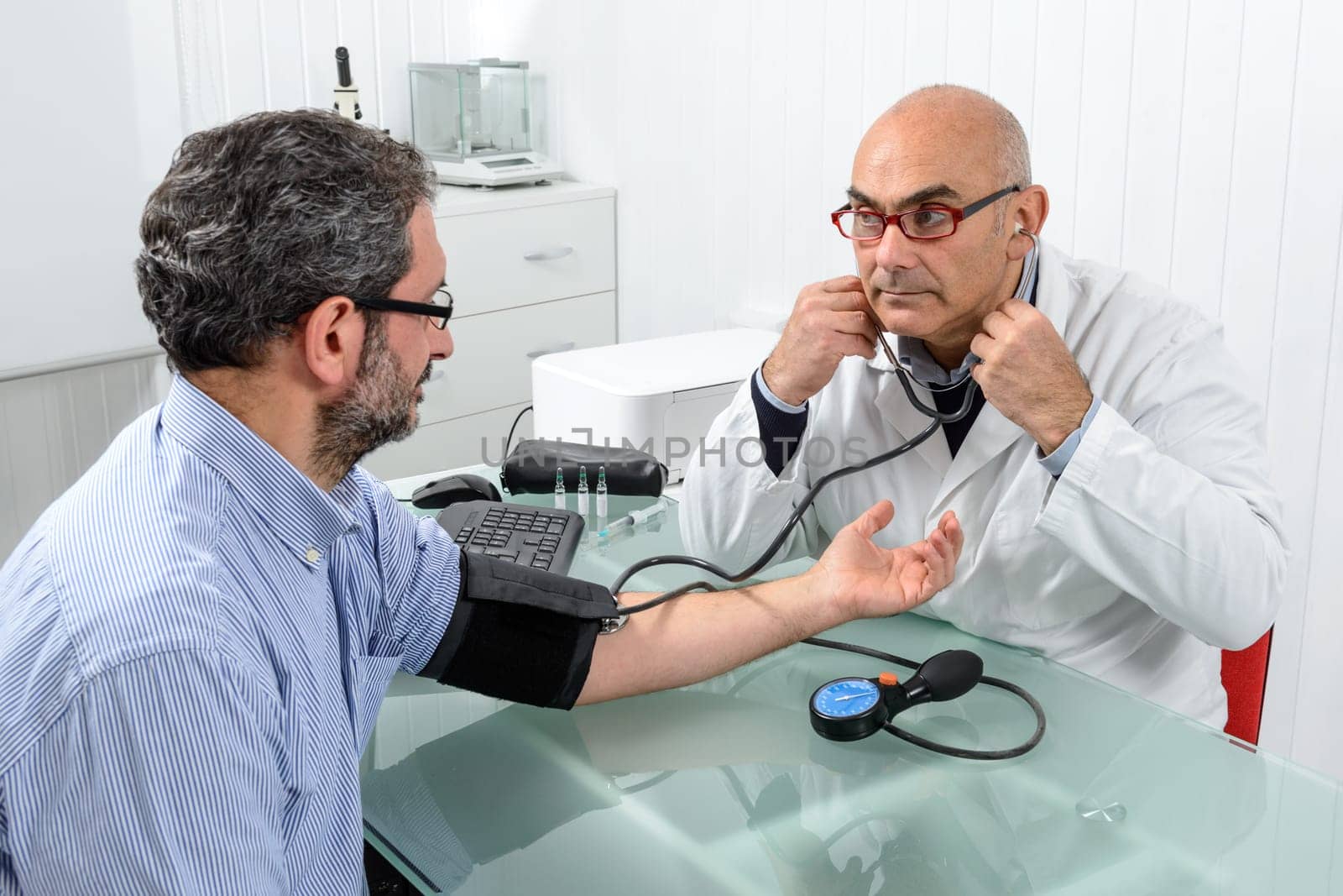 Doctor and patient with blood pressure meter in Doctor's office.
