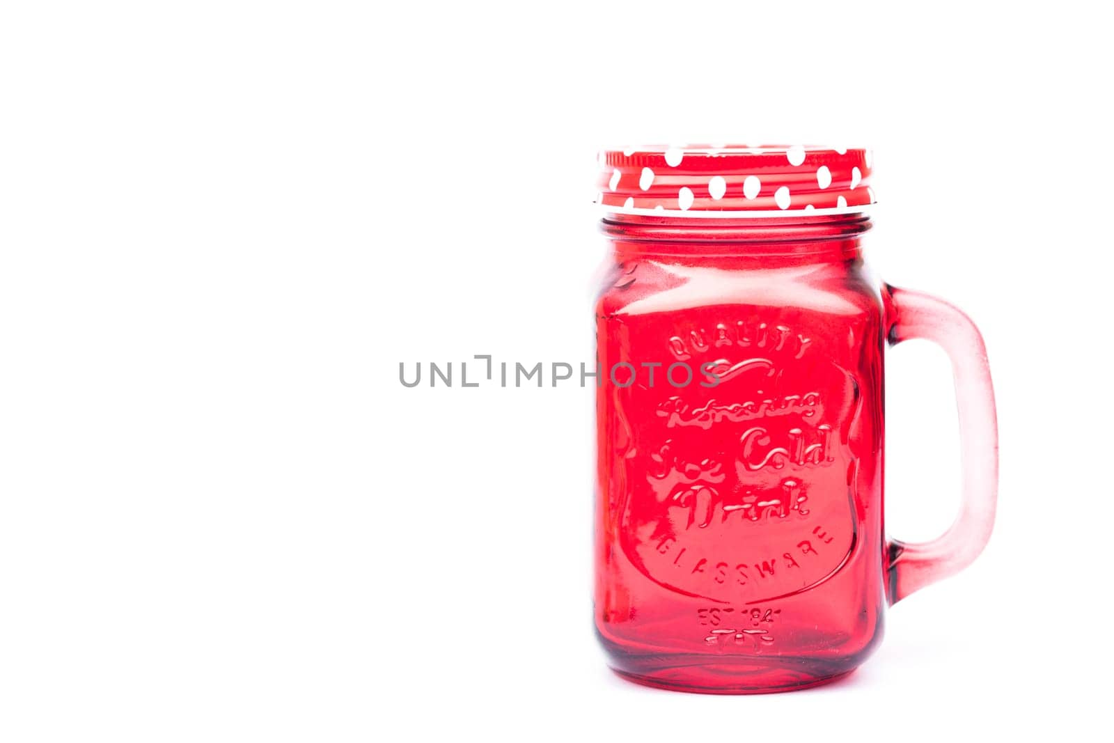 Red mason glass on white background, stock photo