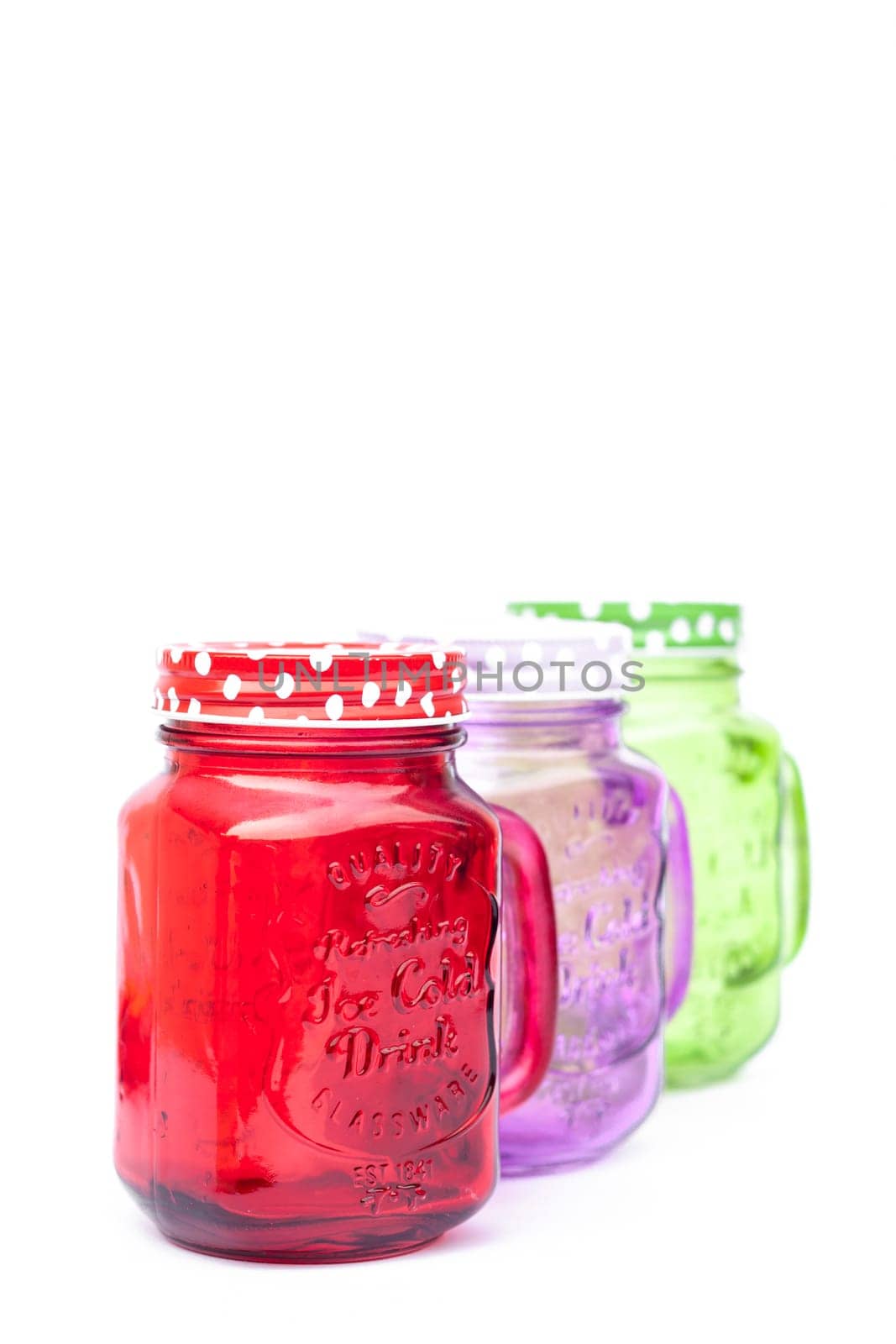 Colourful mason glasses on white background, stock photo
