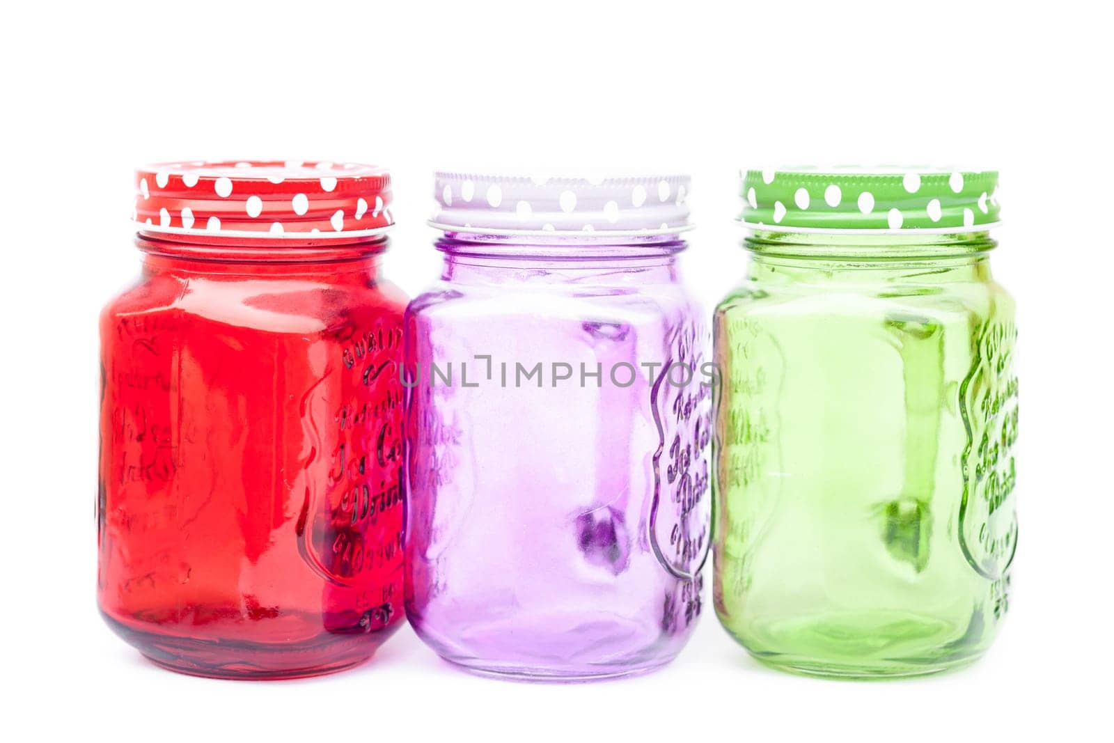 Colourful mason glasses on white background, stock photo