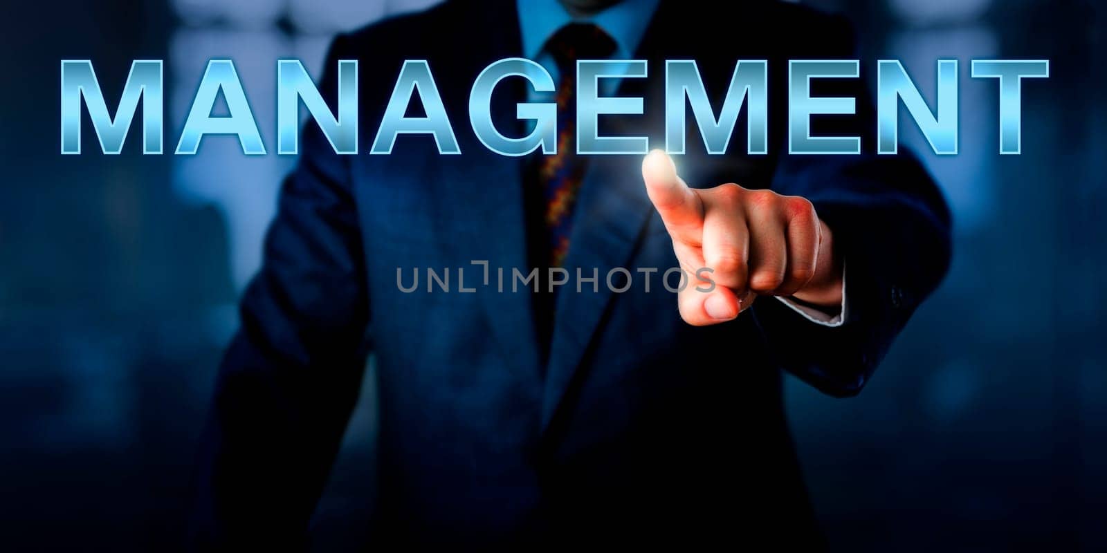 White collar professional pointing at MANAGEMENT on a touch screen interface. Business concept for leadership role, planning function and task of organizing, coordinating, staffing and controlling.