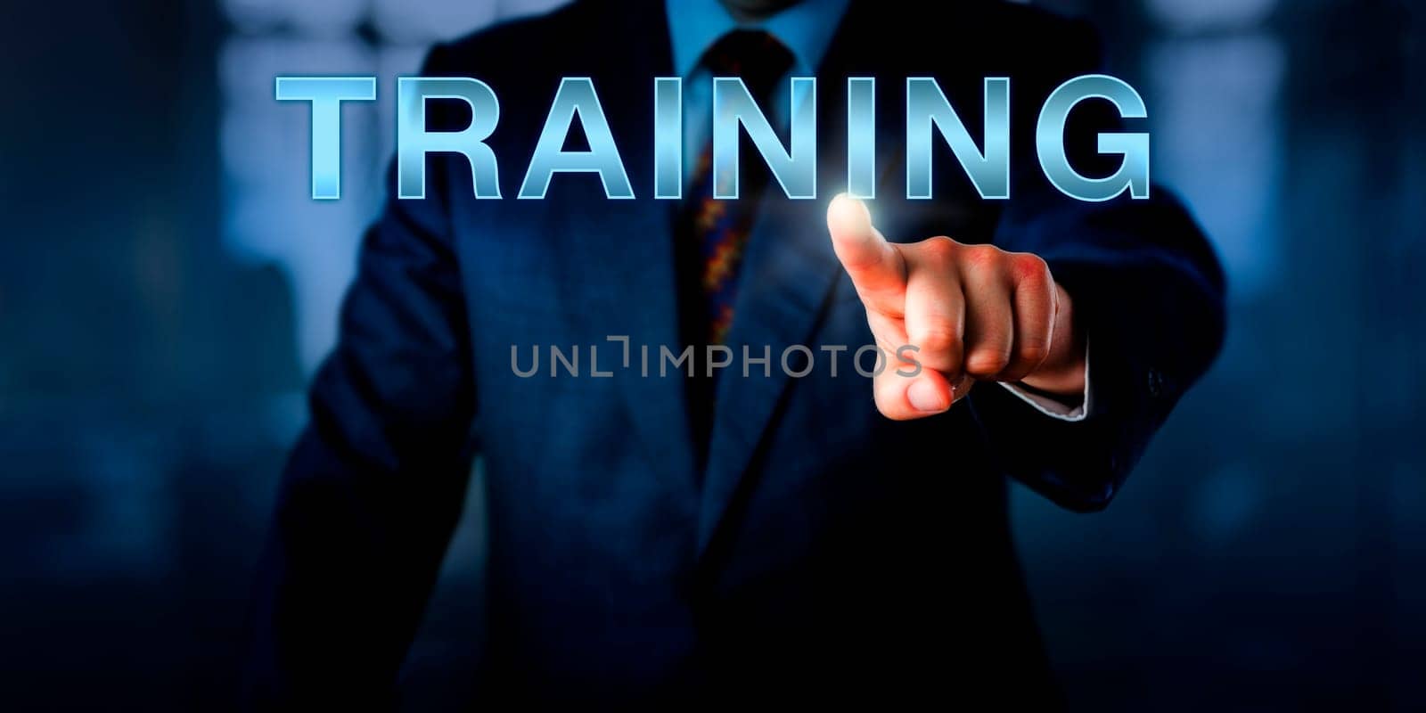 Corporate human resources manager is pressing TRAINING on a touch screen interface. Business concept for continued professional development, life-long learning and improvement of performance.