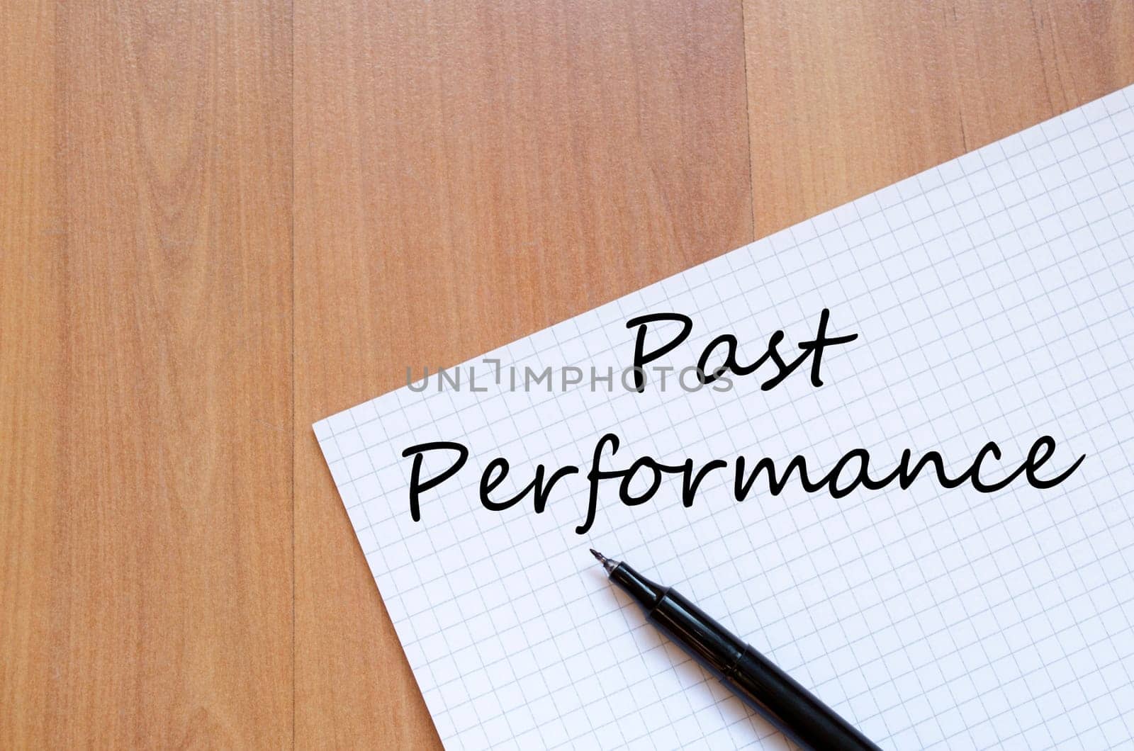Past performance text concept write on notebook with pen