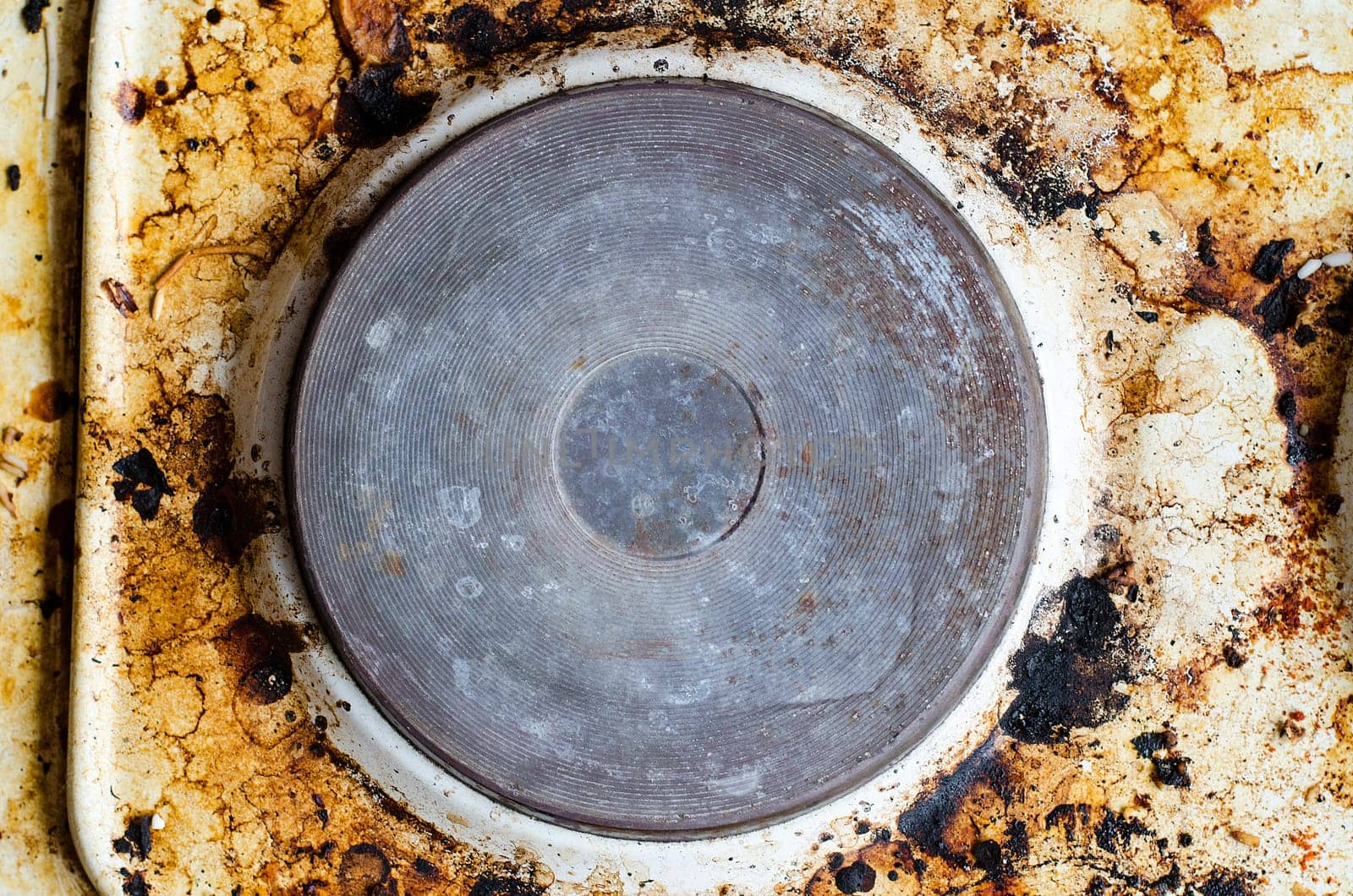 Very dirty hot plate in the kitchen