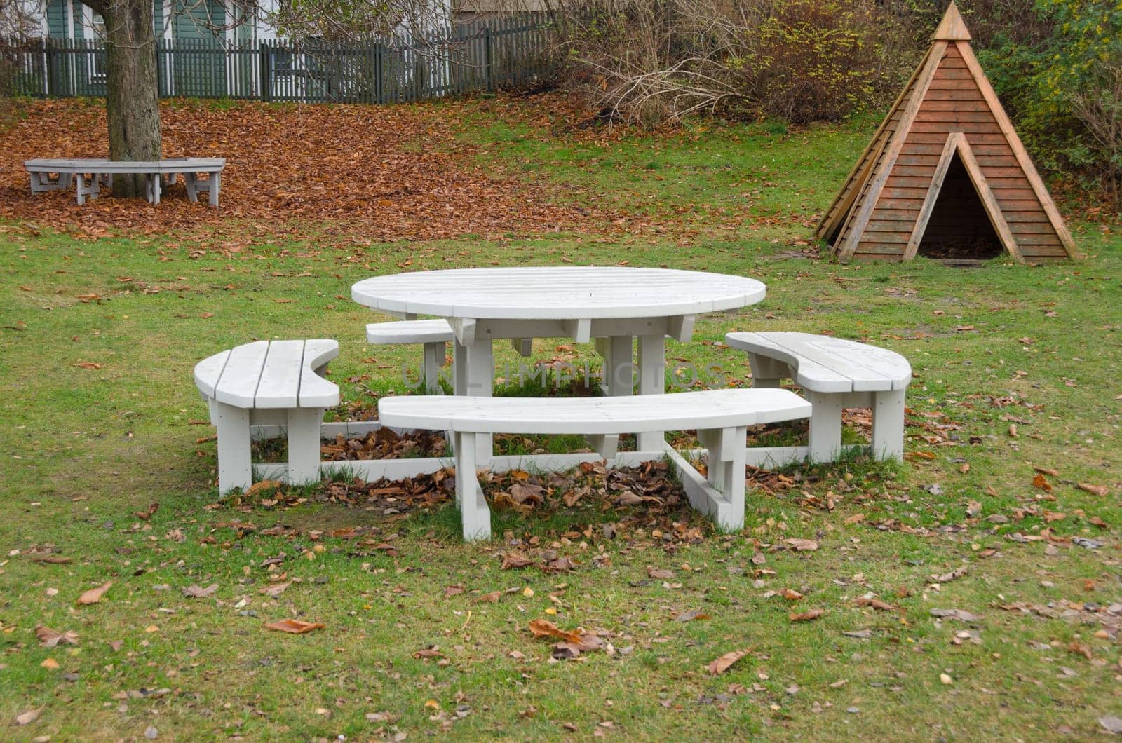 one park bench with a table in the mittle where you can eat