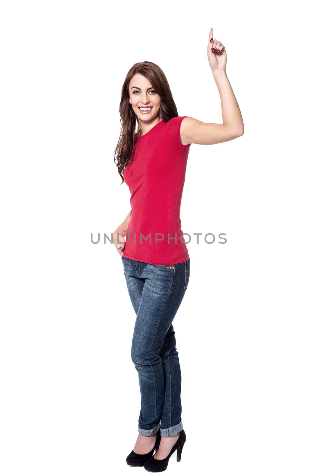 Pretty young woman pointing up over white
