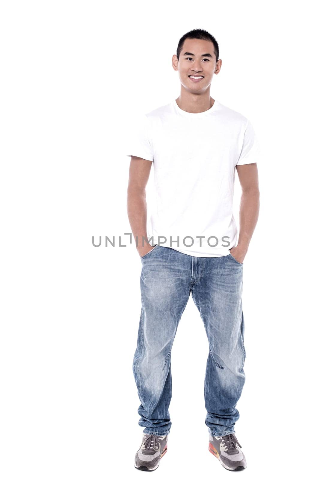 Smiling young man standing over white background