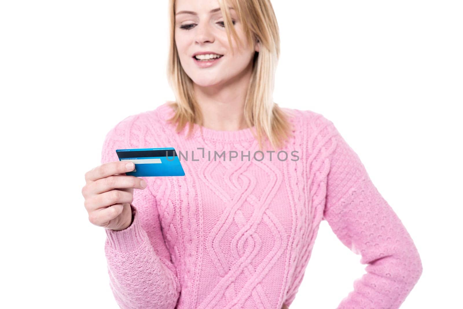Woman in knitwear looking her debit card
