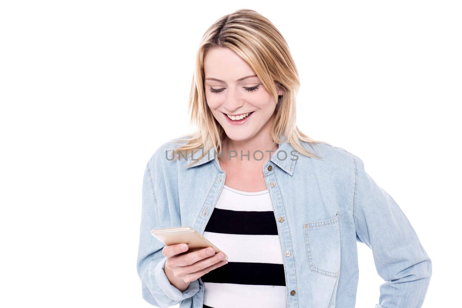 Pretty young girl looking into her mobile phone