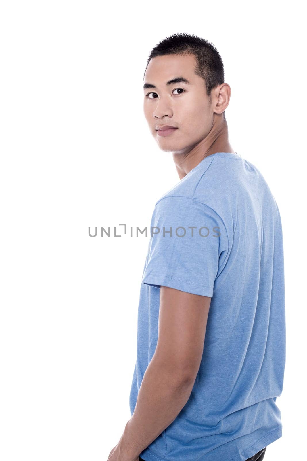 Casual young man looking over his shoulder