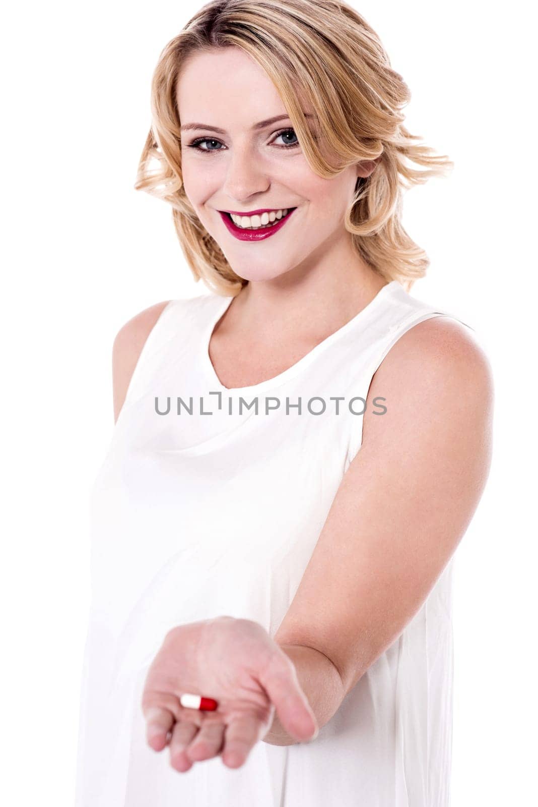 Beautiful lady holding a medicine pill in her hand
