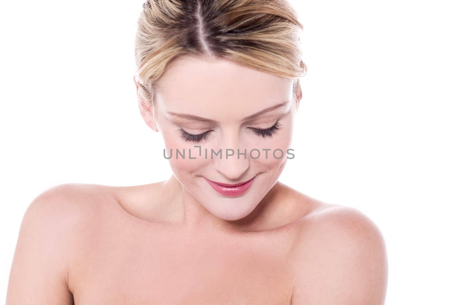 Spa lady looking down with bare shoulders
