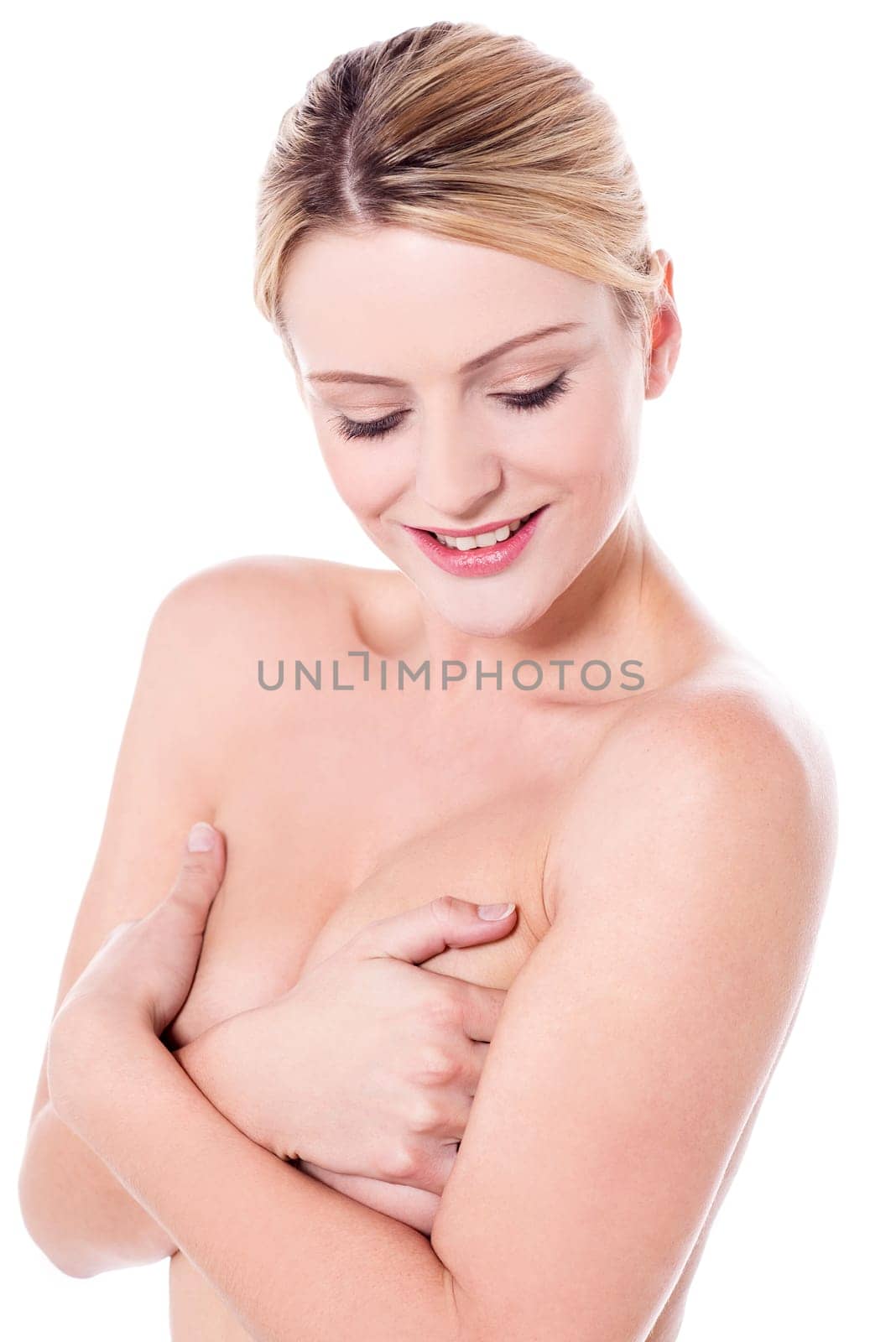 Unclad woman covering her breasts