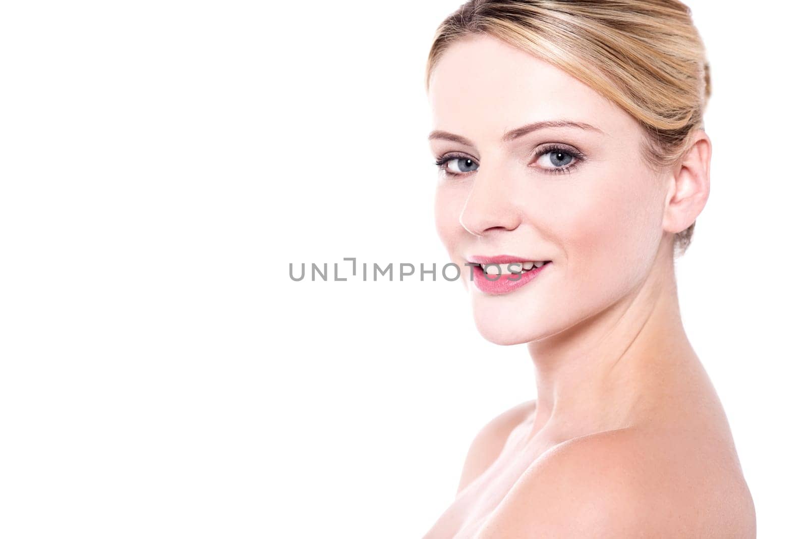 Young woman with bare shoulders posing to camera