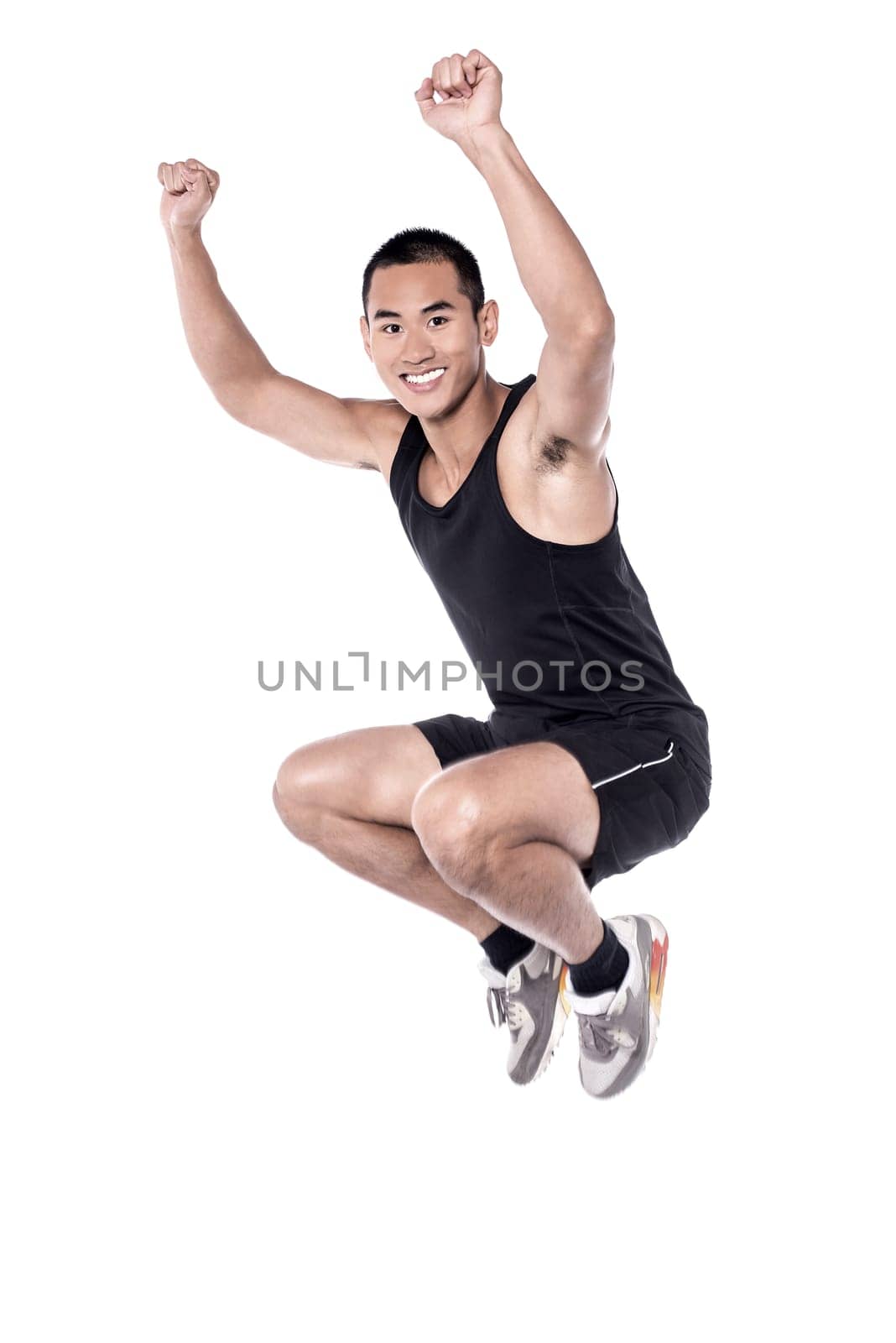 Handsome guy jumping in black clothes over white