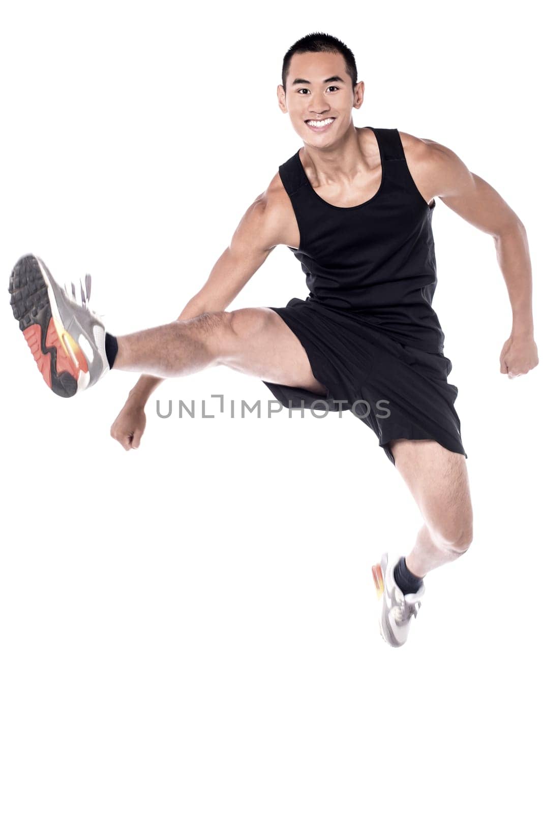 Handsome athlete before workout, stretching legs