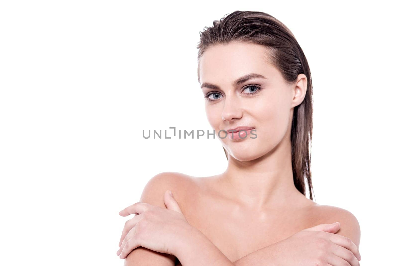 Pretty young lady covering her shoulders with hands