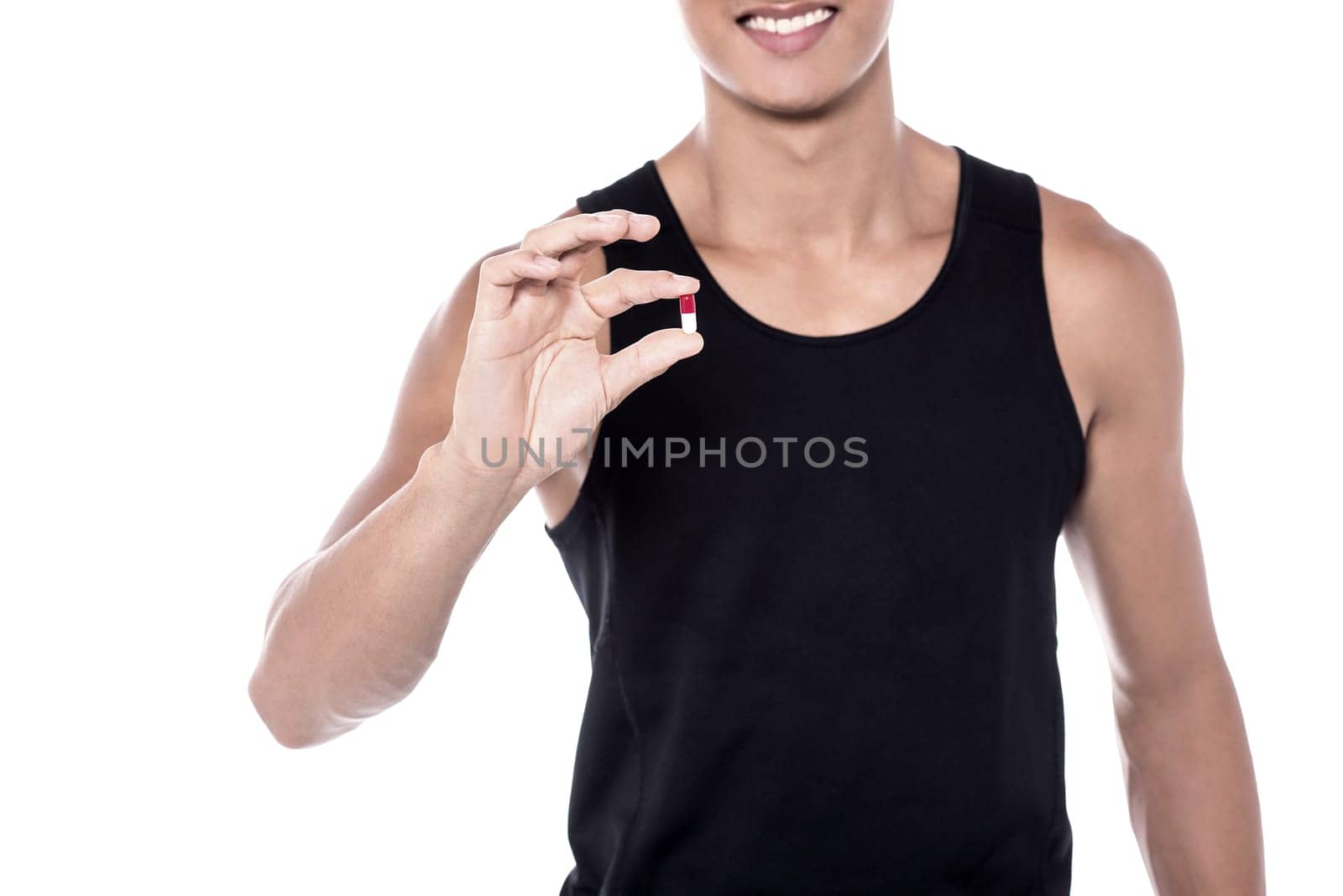 Cropped image of sports man showing vitamin pill
