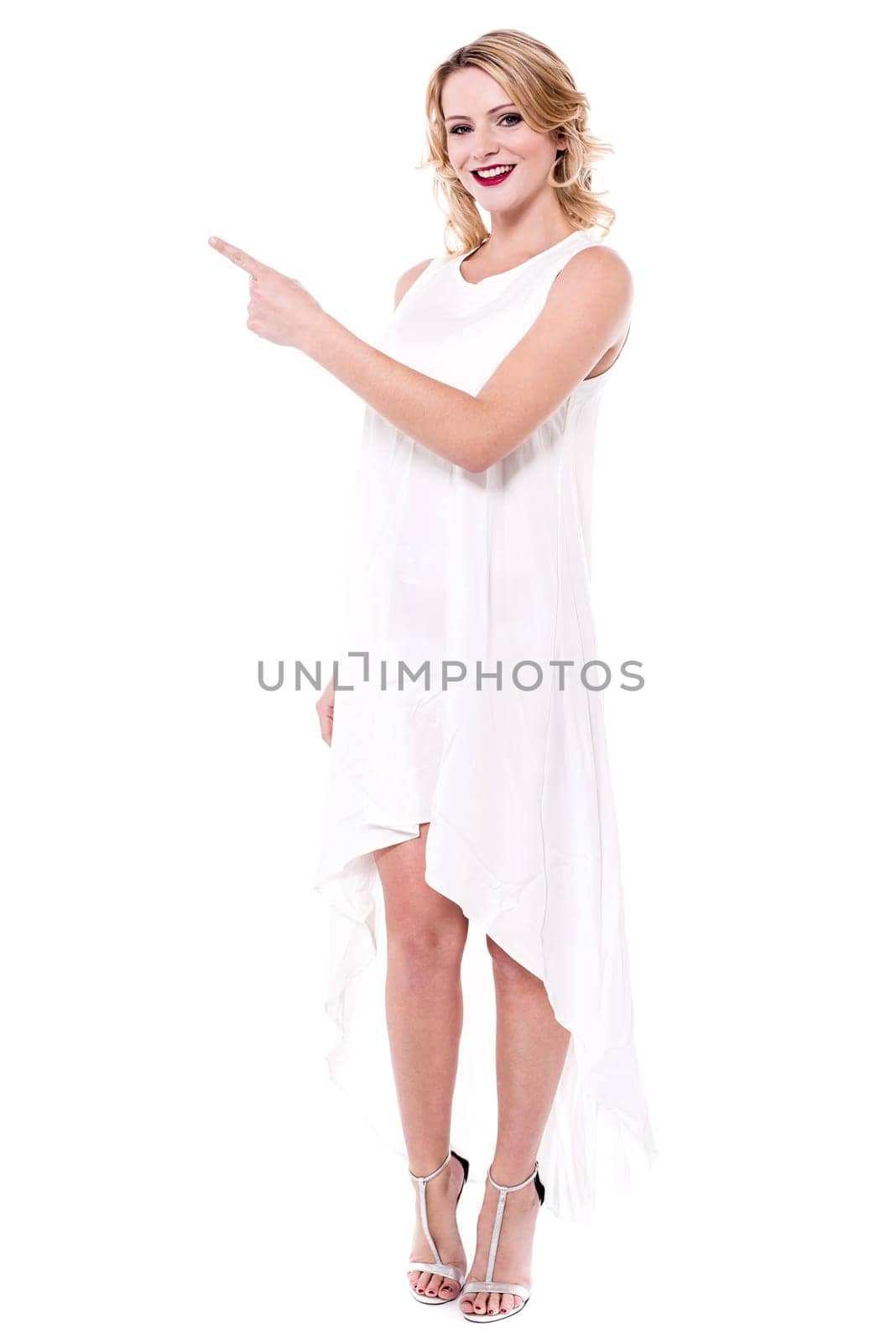 Attractive young woman pointing at copy space