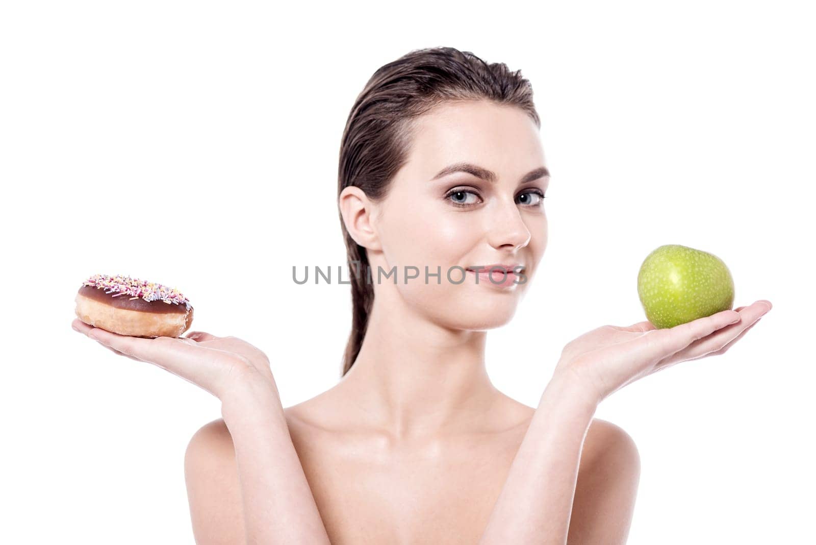 Young woman with green apple and peanut donut