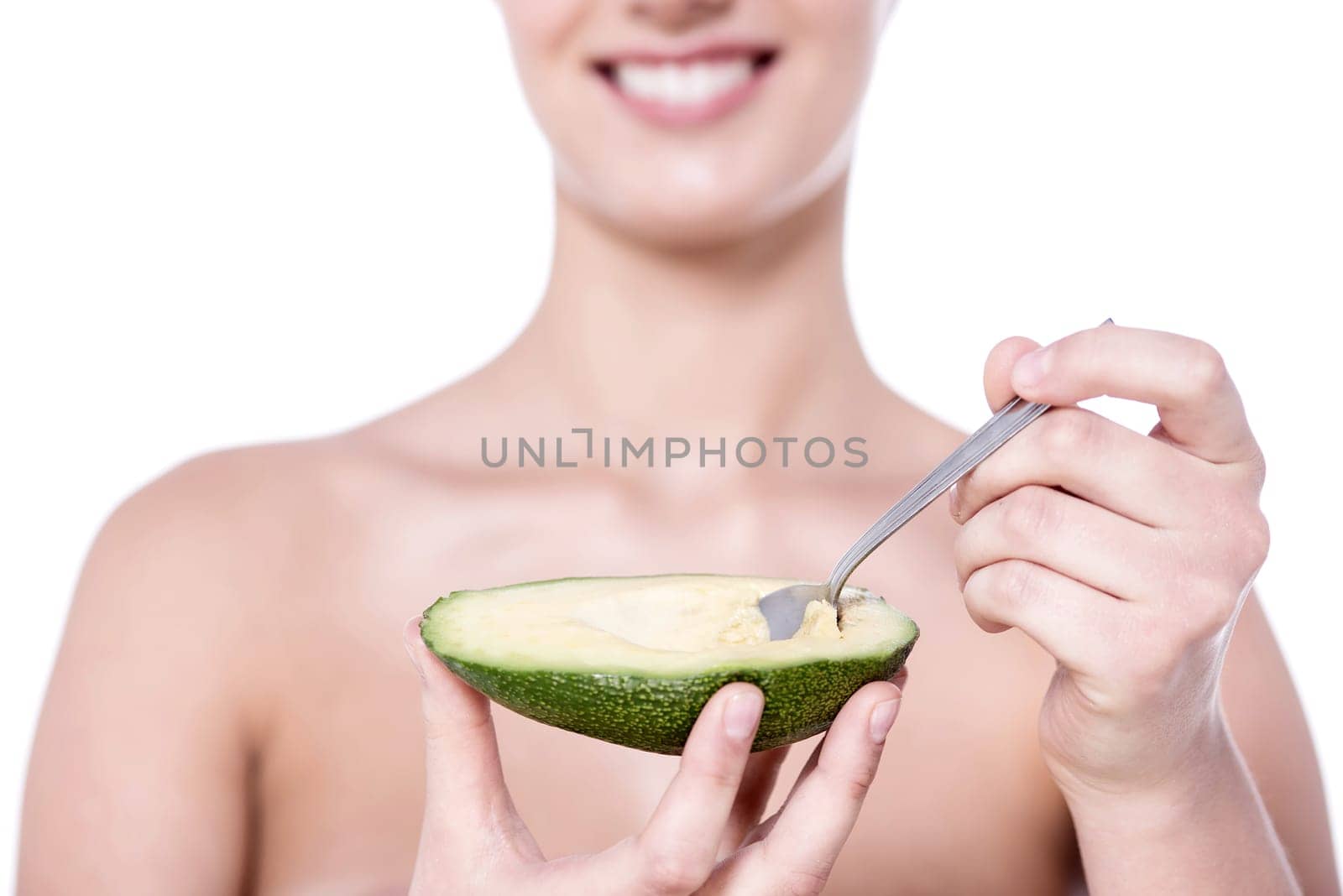 Cropped image of a woman eating avocado
