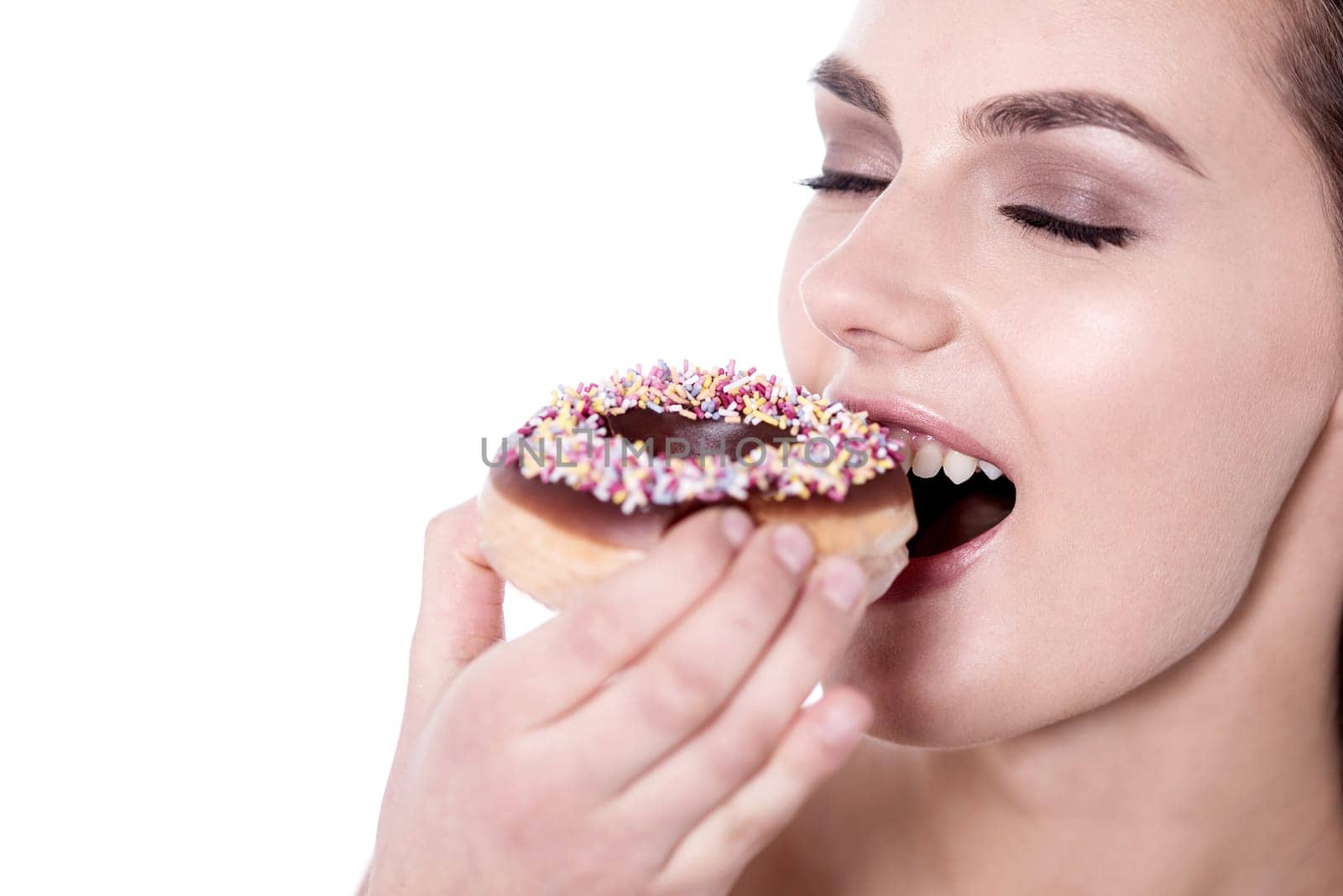 Young woman enjoying her snack against white
