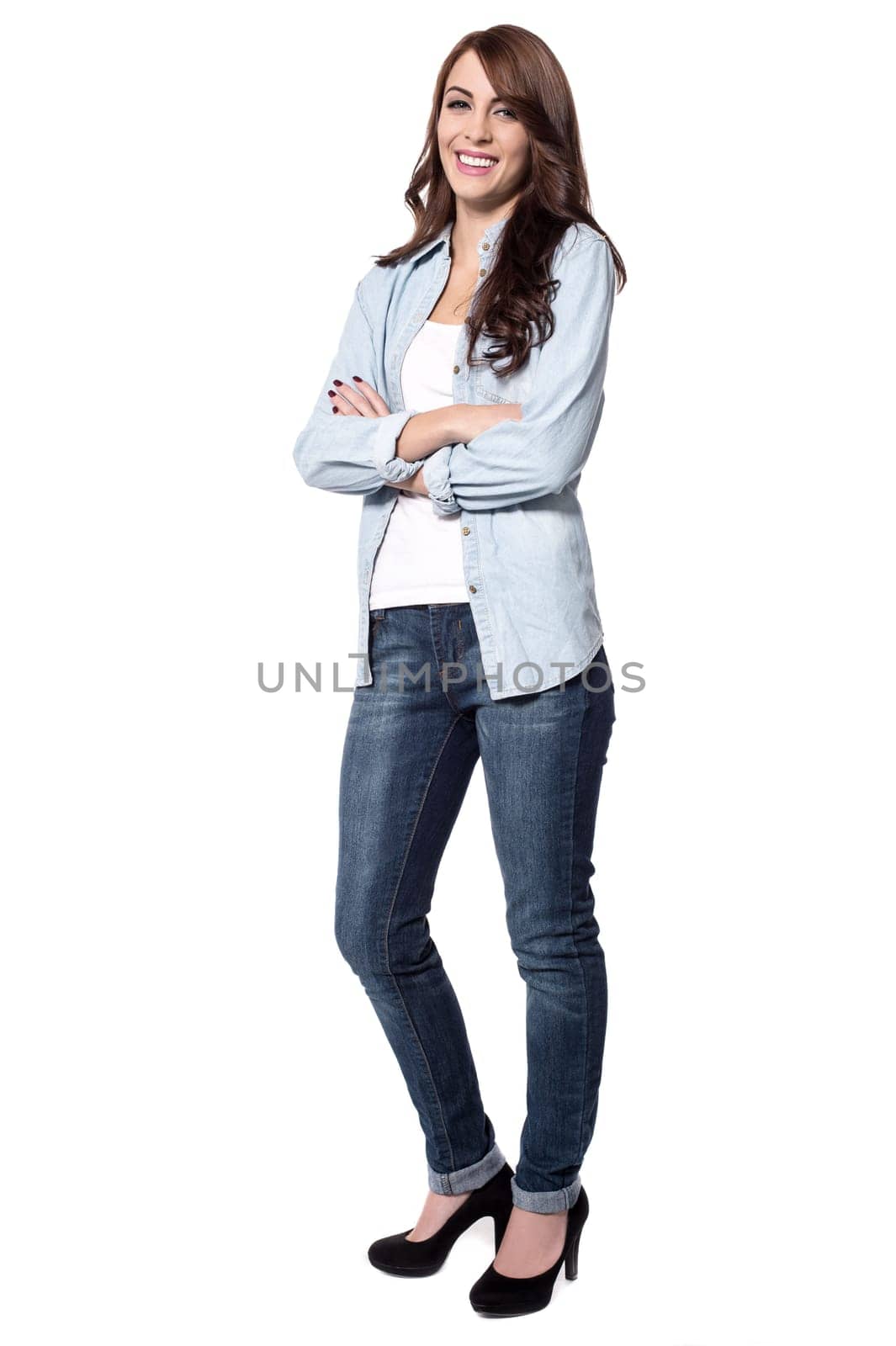Confident woman against a white background with crossed arms
