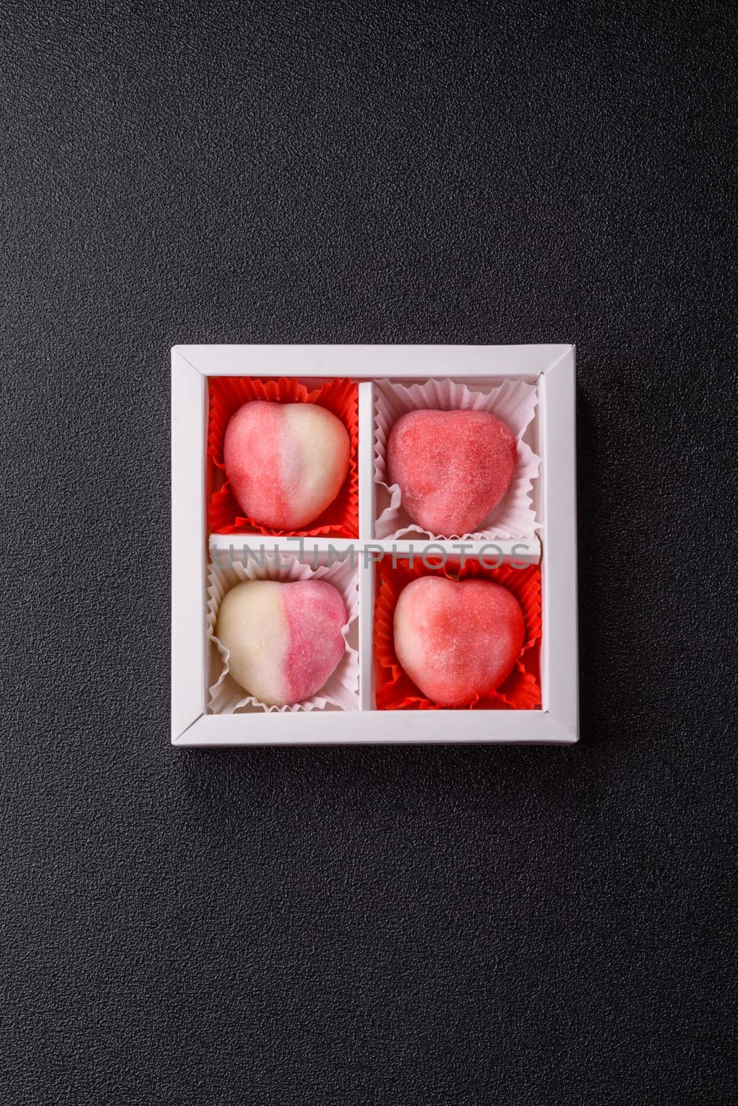 Delicious sweet mochi in the shape of red hearts for the holiday of Valentine's Day
