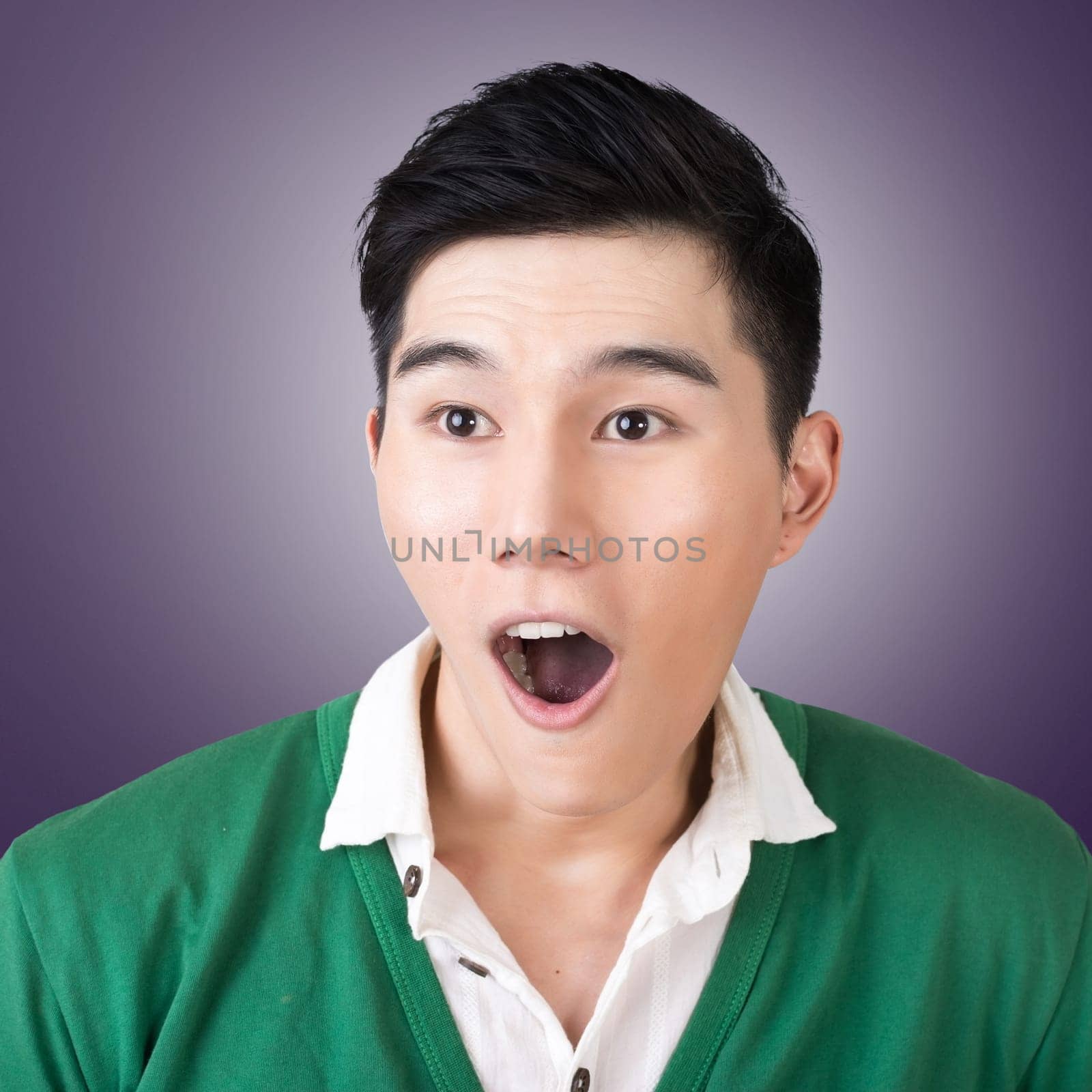 Funny facial expression, closeup Asian young man.