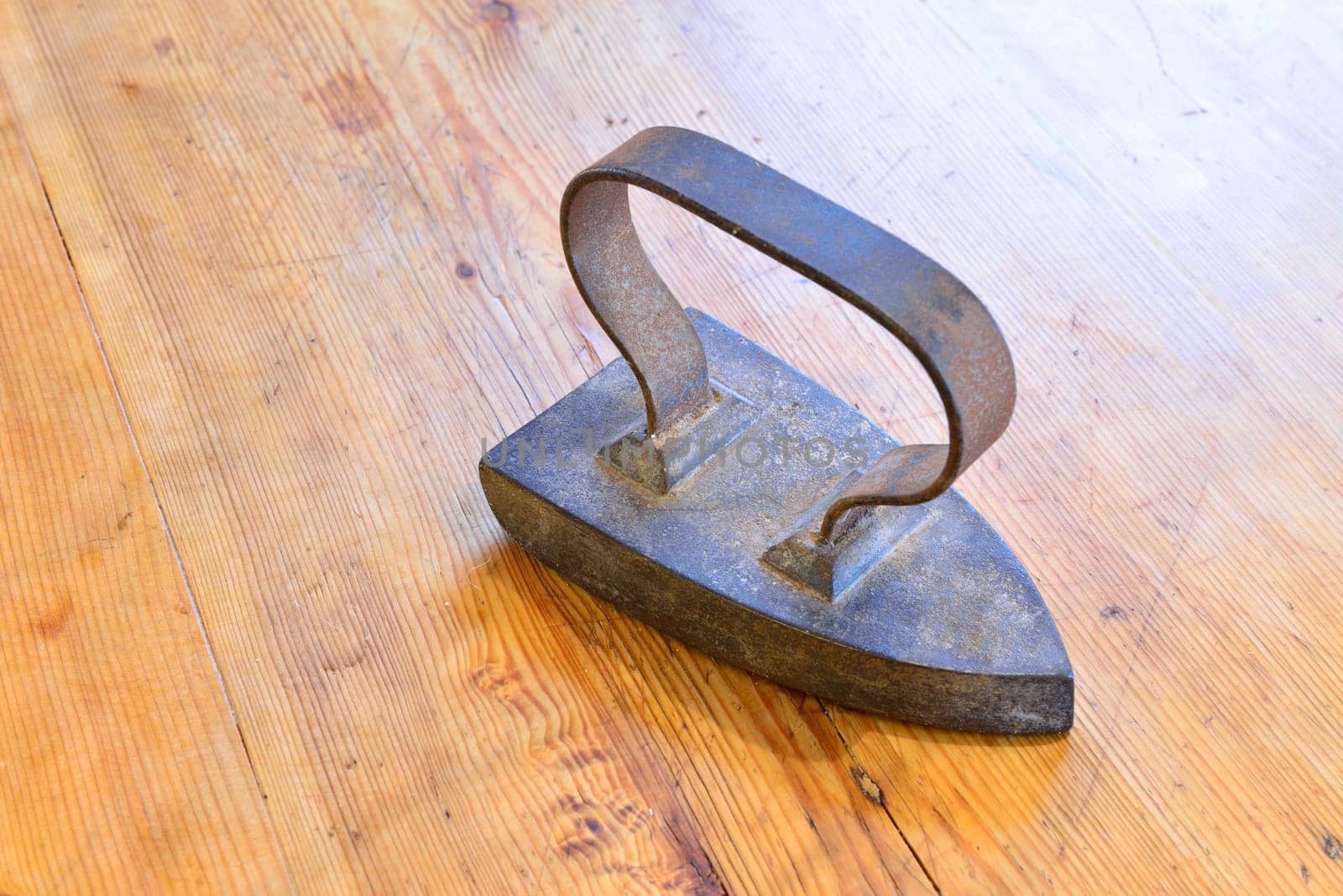 Old iron on an old wooden table