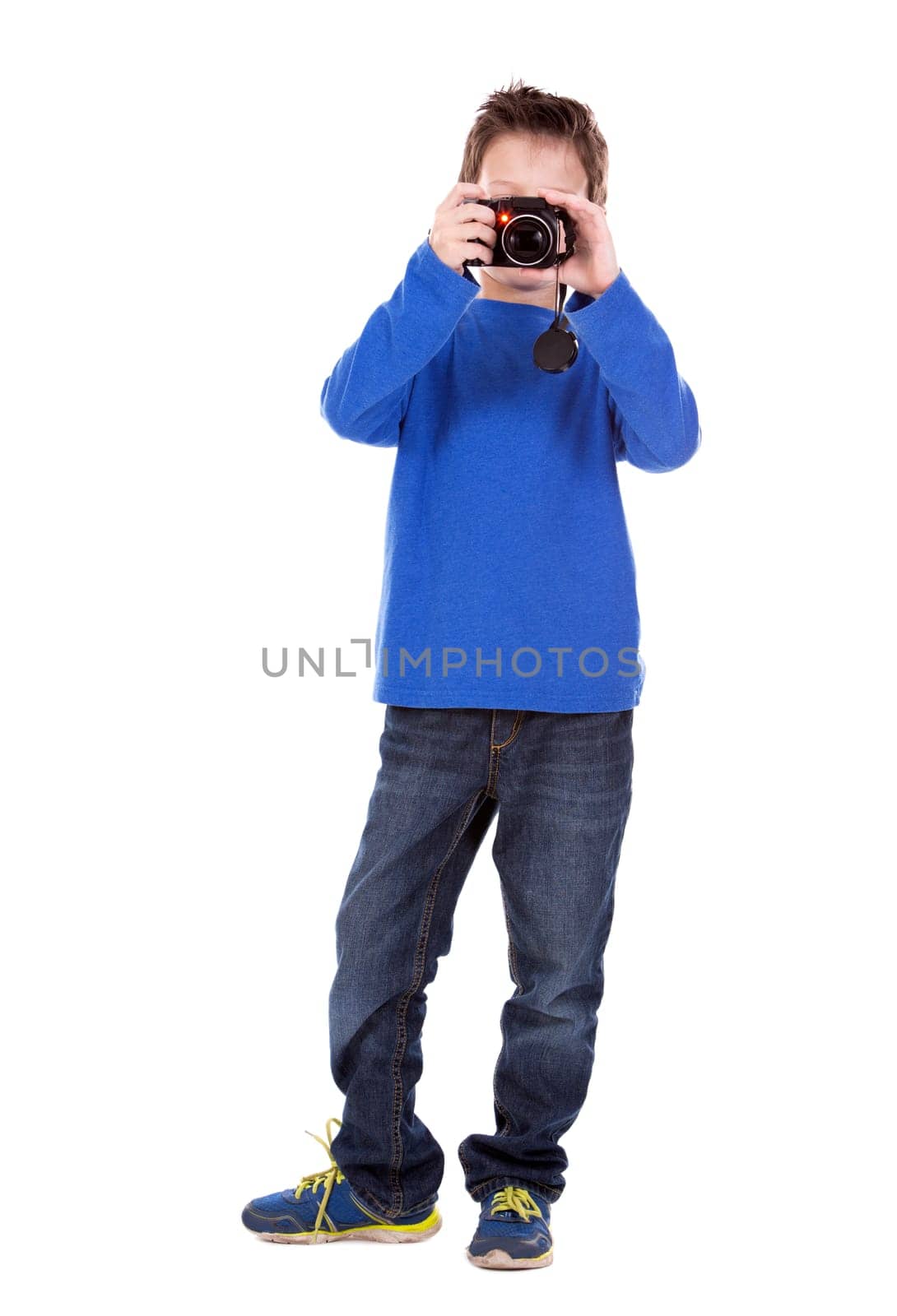 six years old boy taking photos with his camera on white background