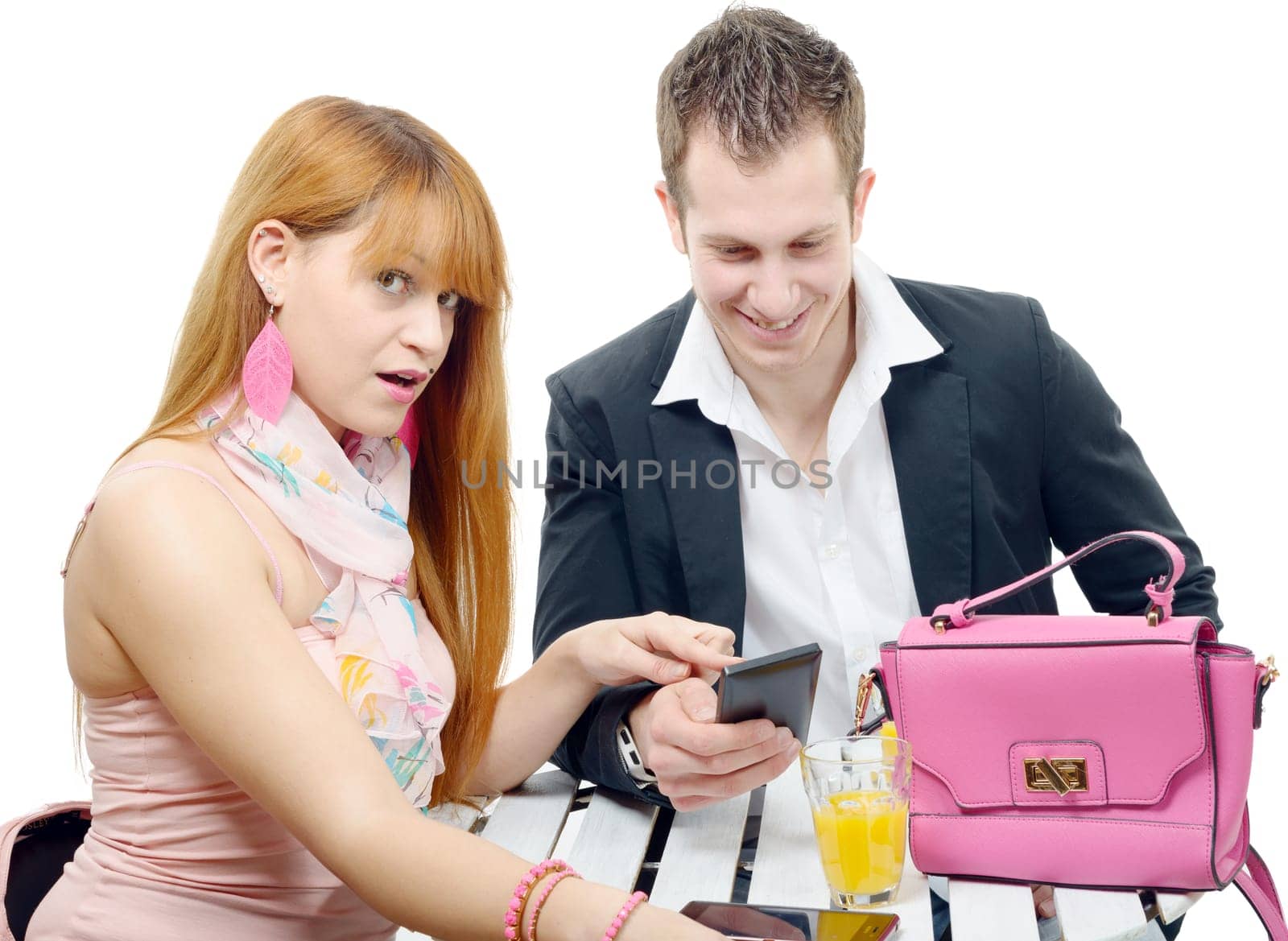 a young couple with a smartphone in a coffee shop terrace