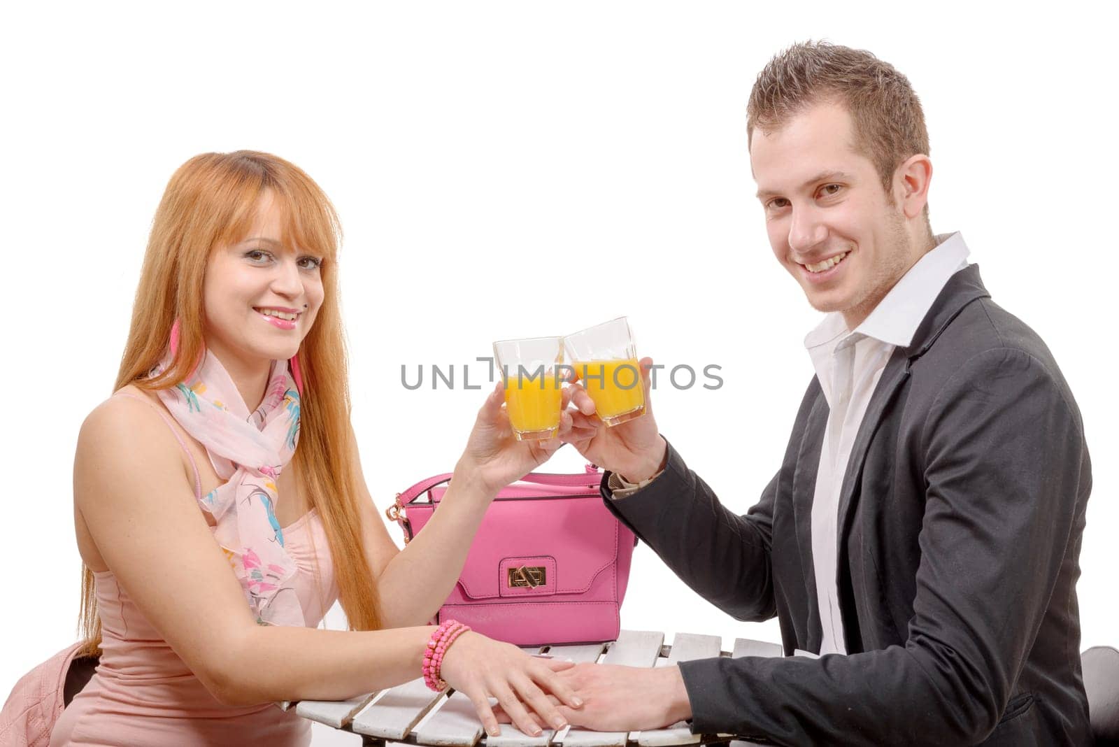 happy young couple drinking orange juice, isolated on white background