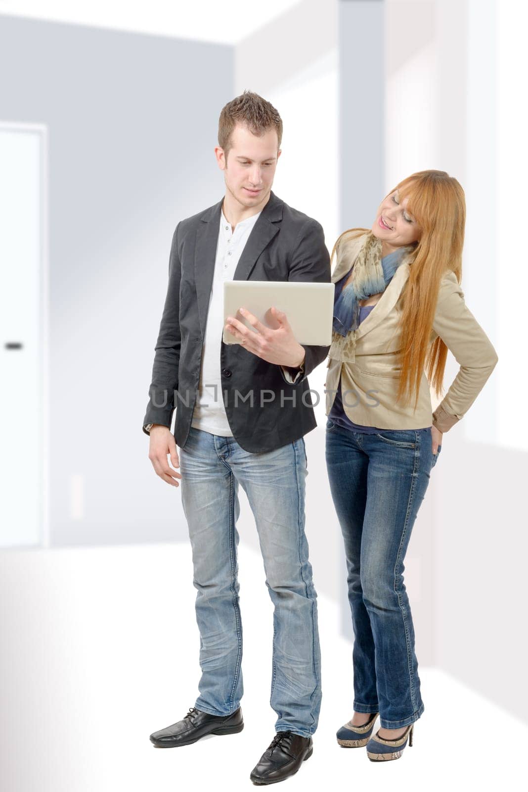 two young business people working together with a laptop