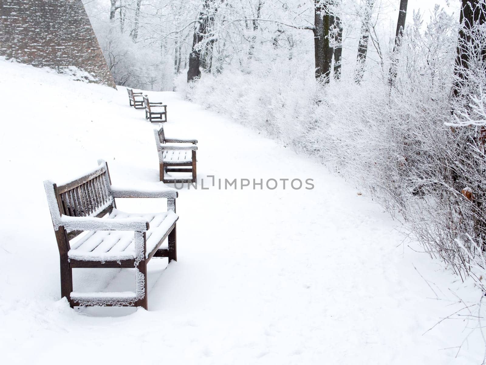 Detail of weathered wooden bench covered in snow, winter time illustration