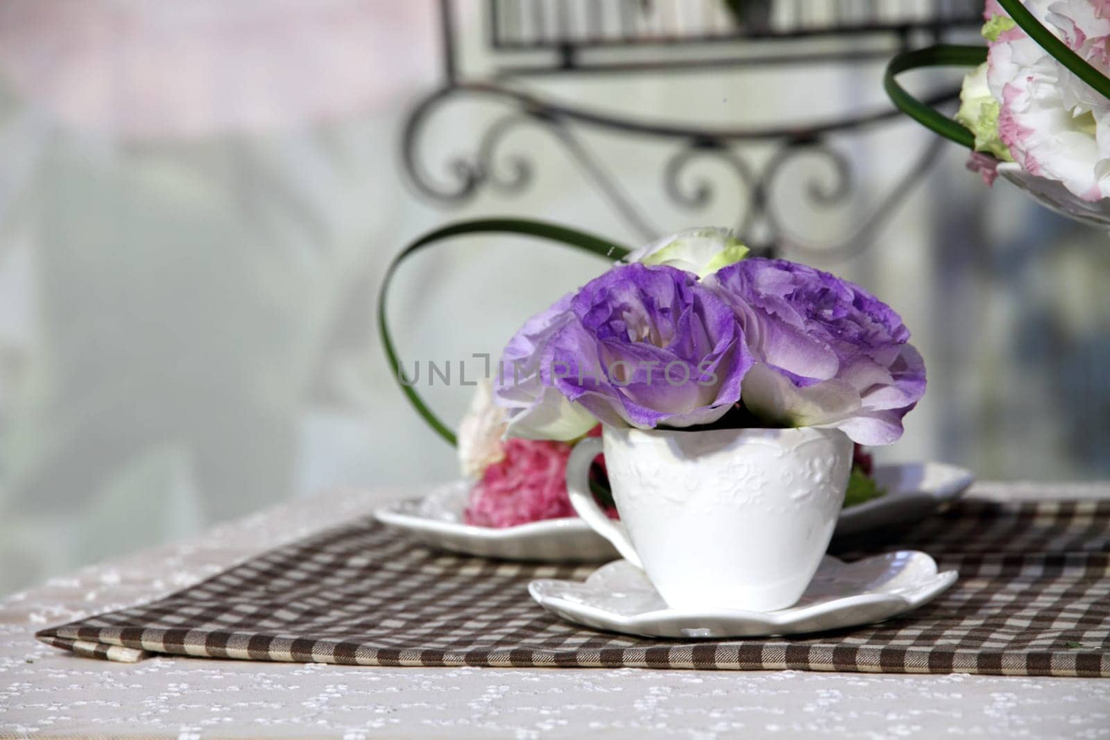 Brunch of blossom eustoma flowers in a white cup