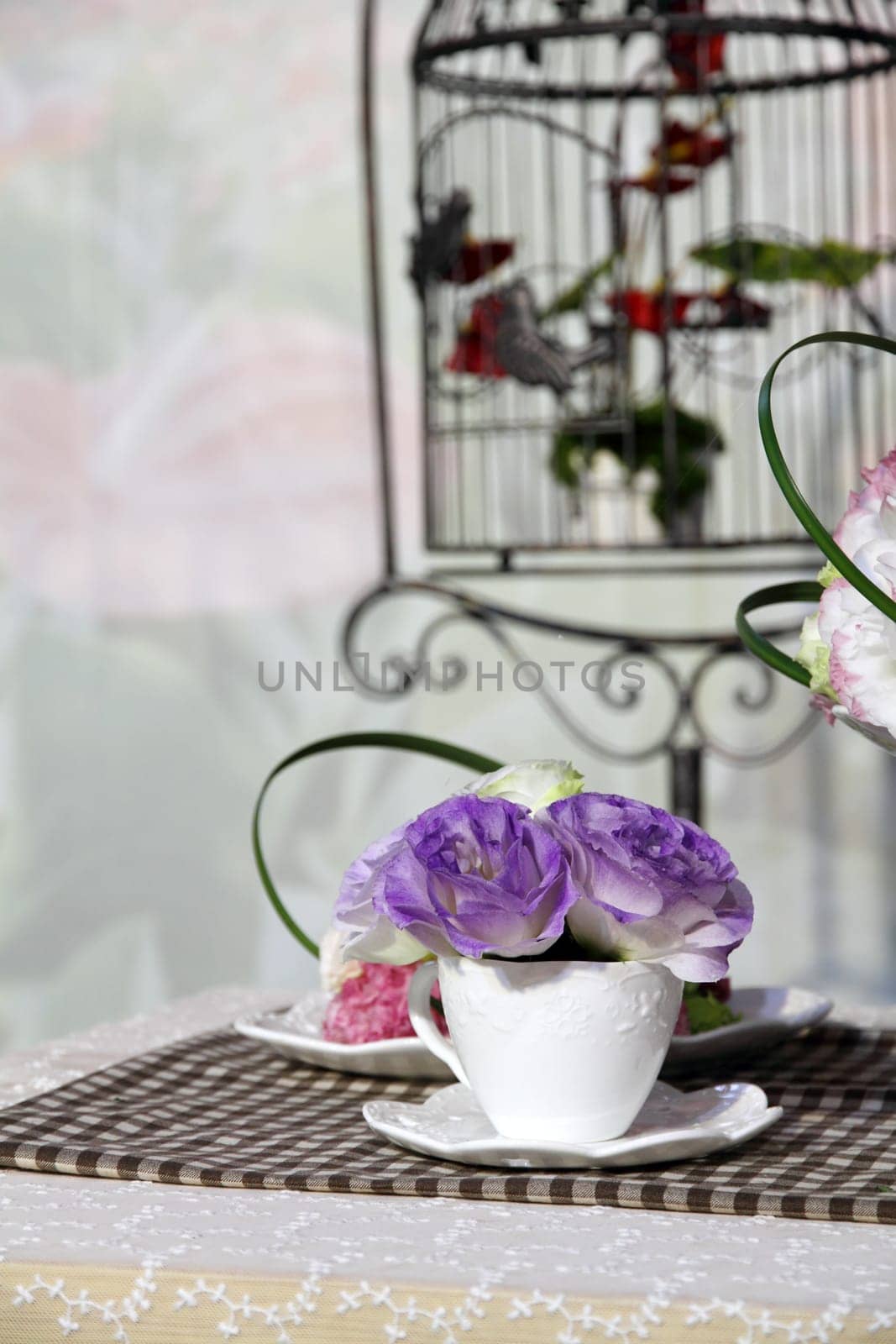 Brunch of blossom eustoma flowers in a white cup