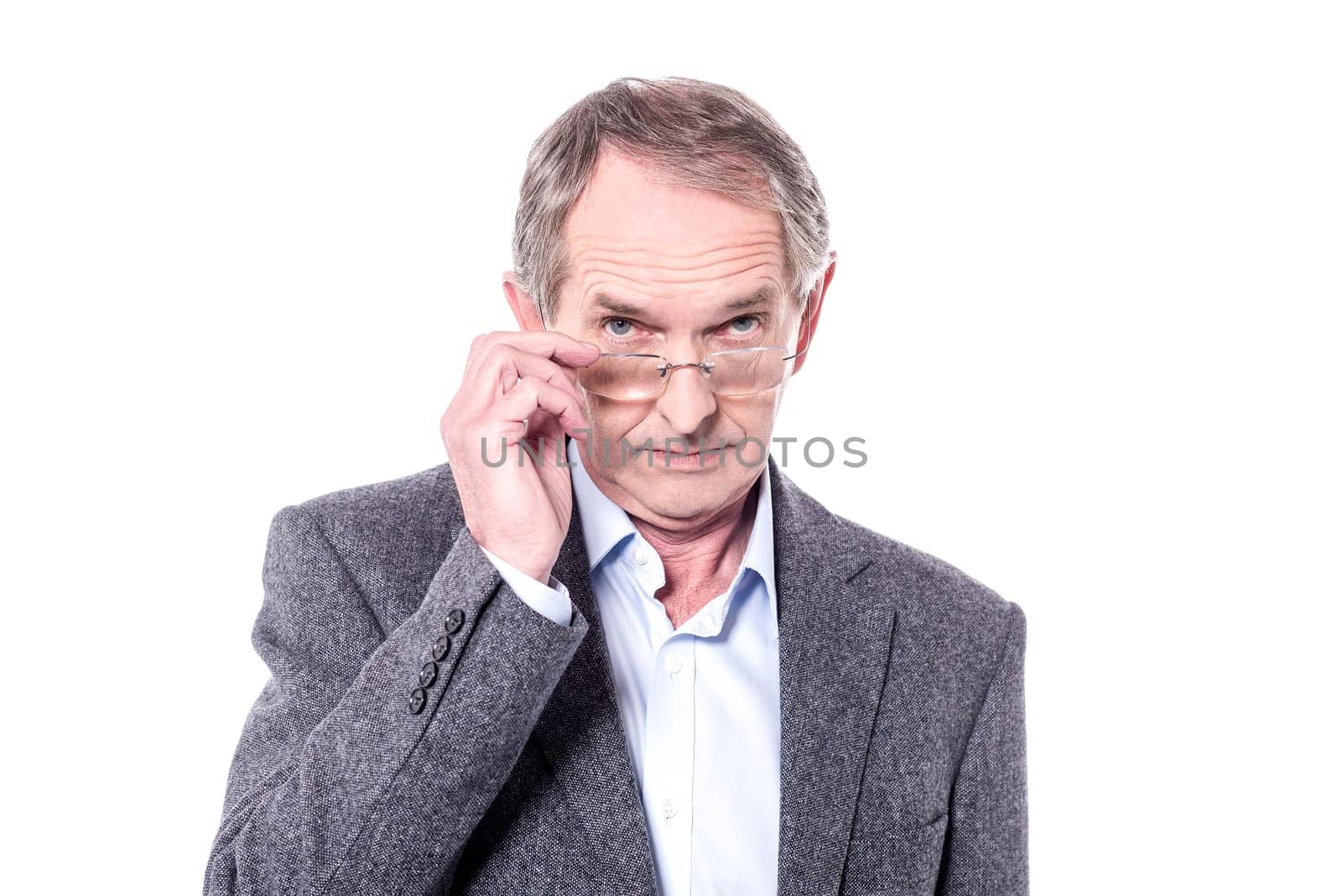 Senior man removing his spectacles over white