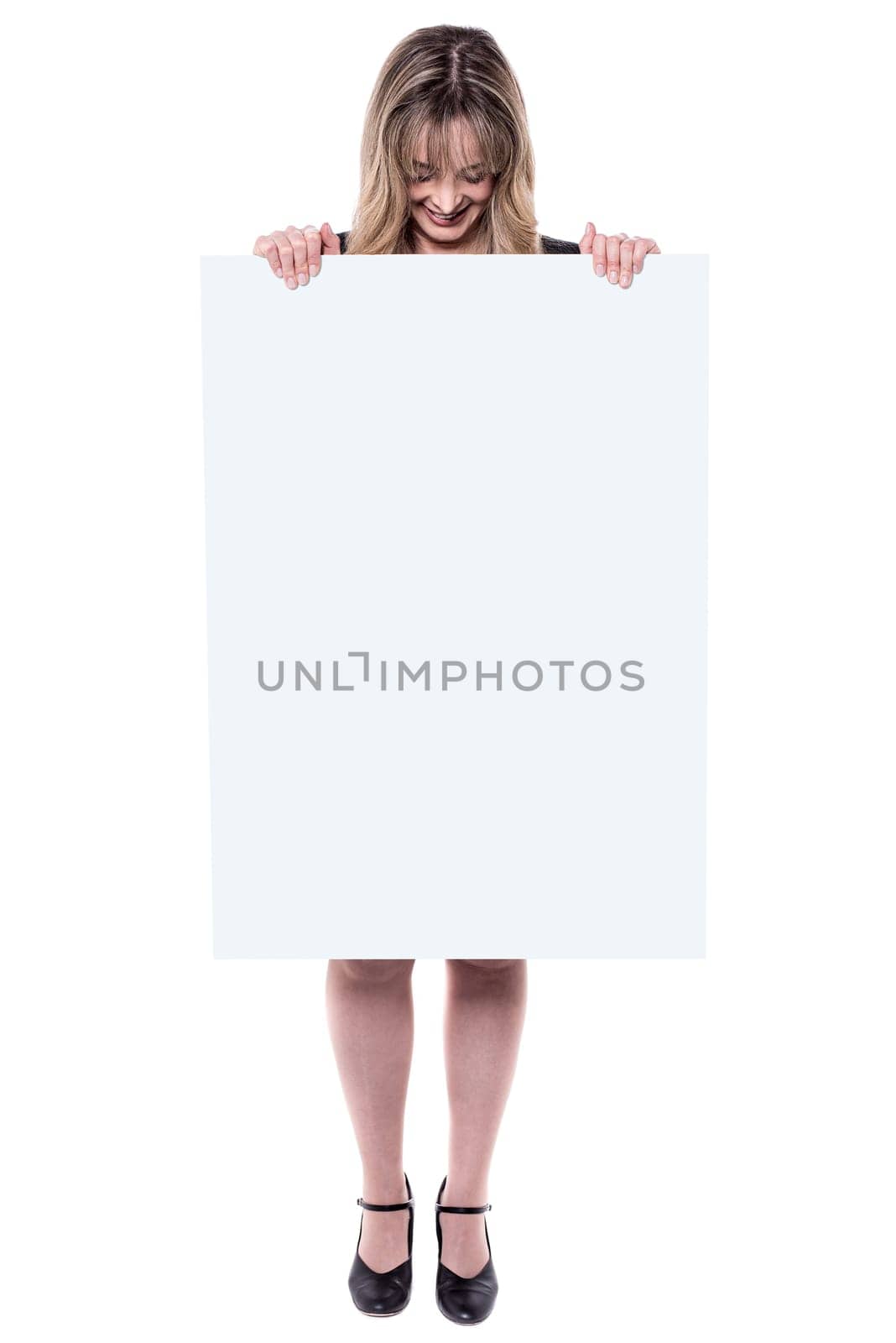 Middle aged businesswoman hiding herself with placard