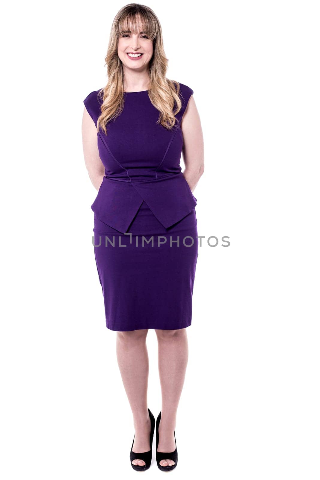 Beautiful middle aged woman posing to camera in party wear.