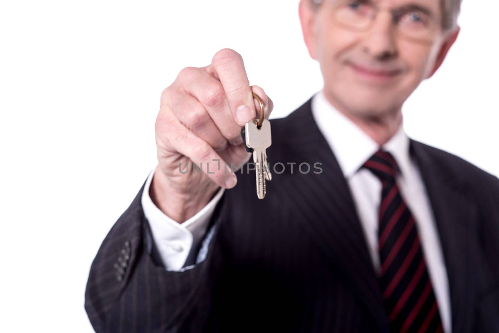 Blurred image of senior businessman holding house key