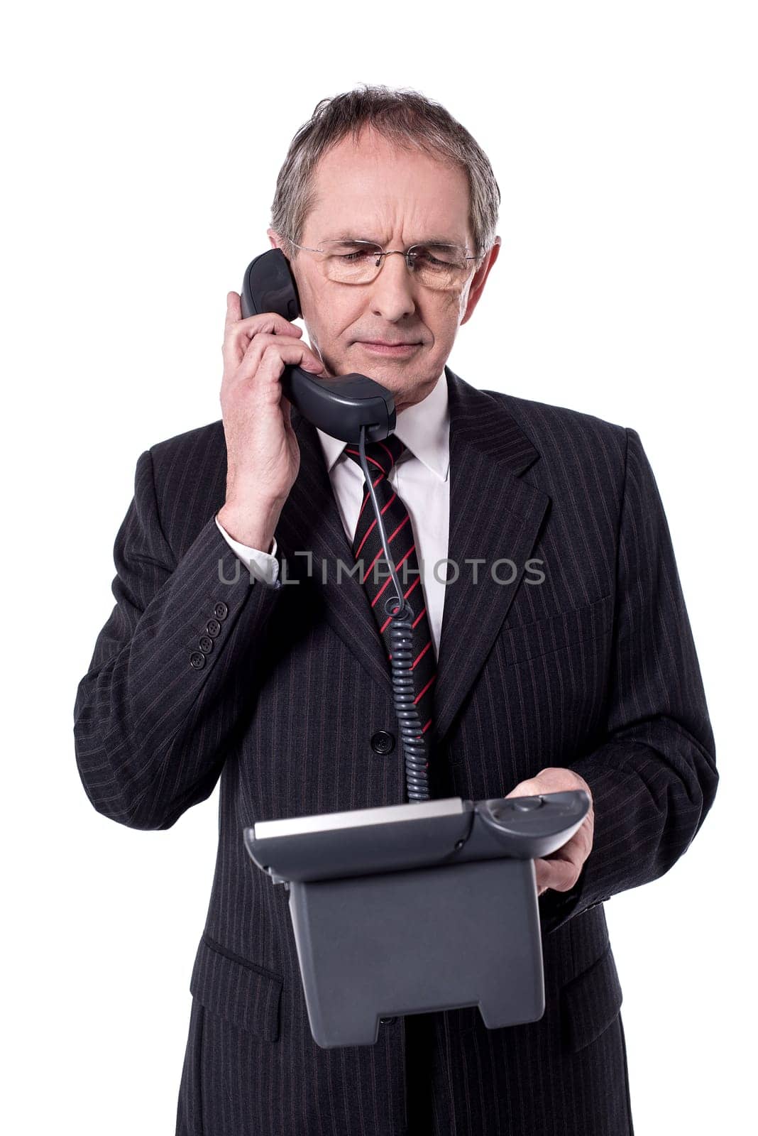 Senior businessman communicating in telephone over white