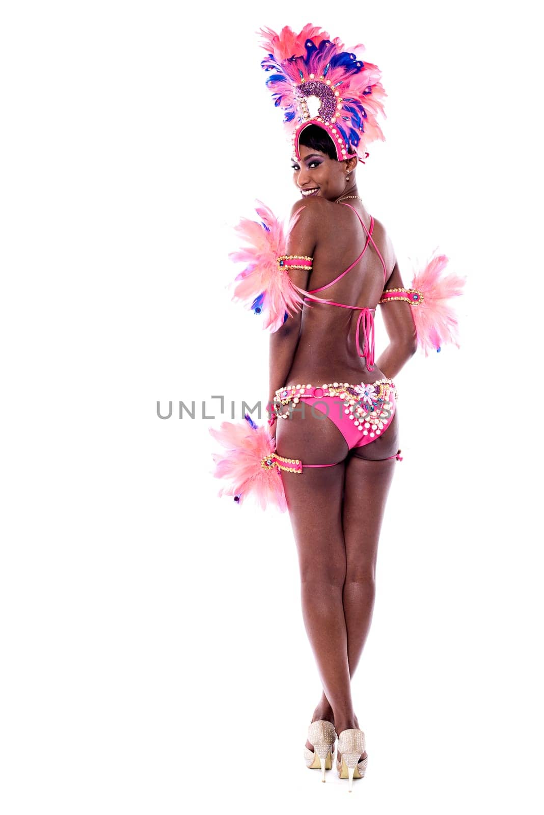 Back view of a young woman dancer in action with hands on hips