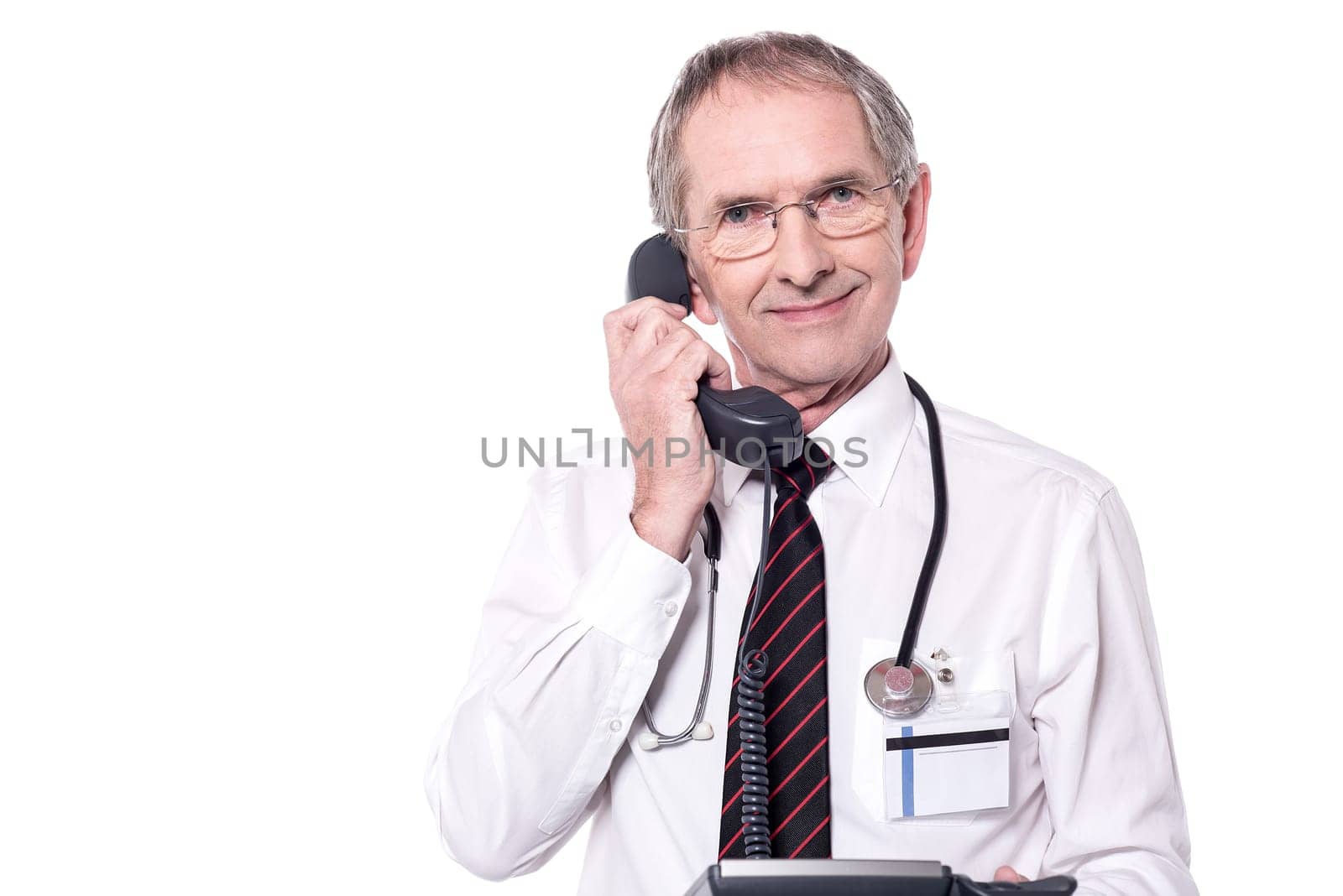 Senior male doctor talking in telephone over white