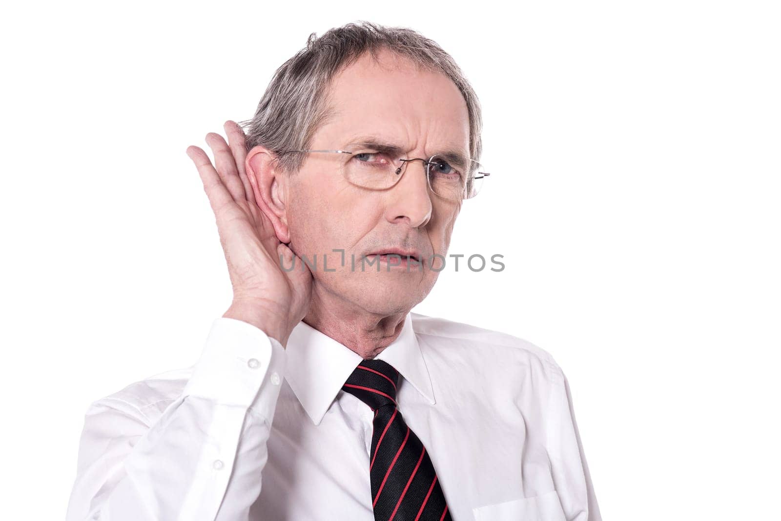 Curious senior man keeping hand near ear