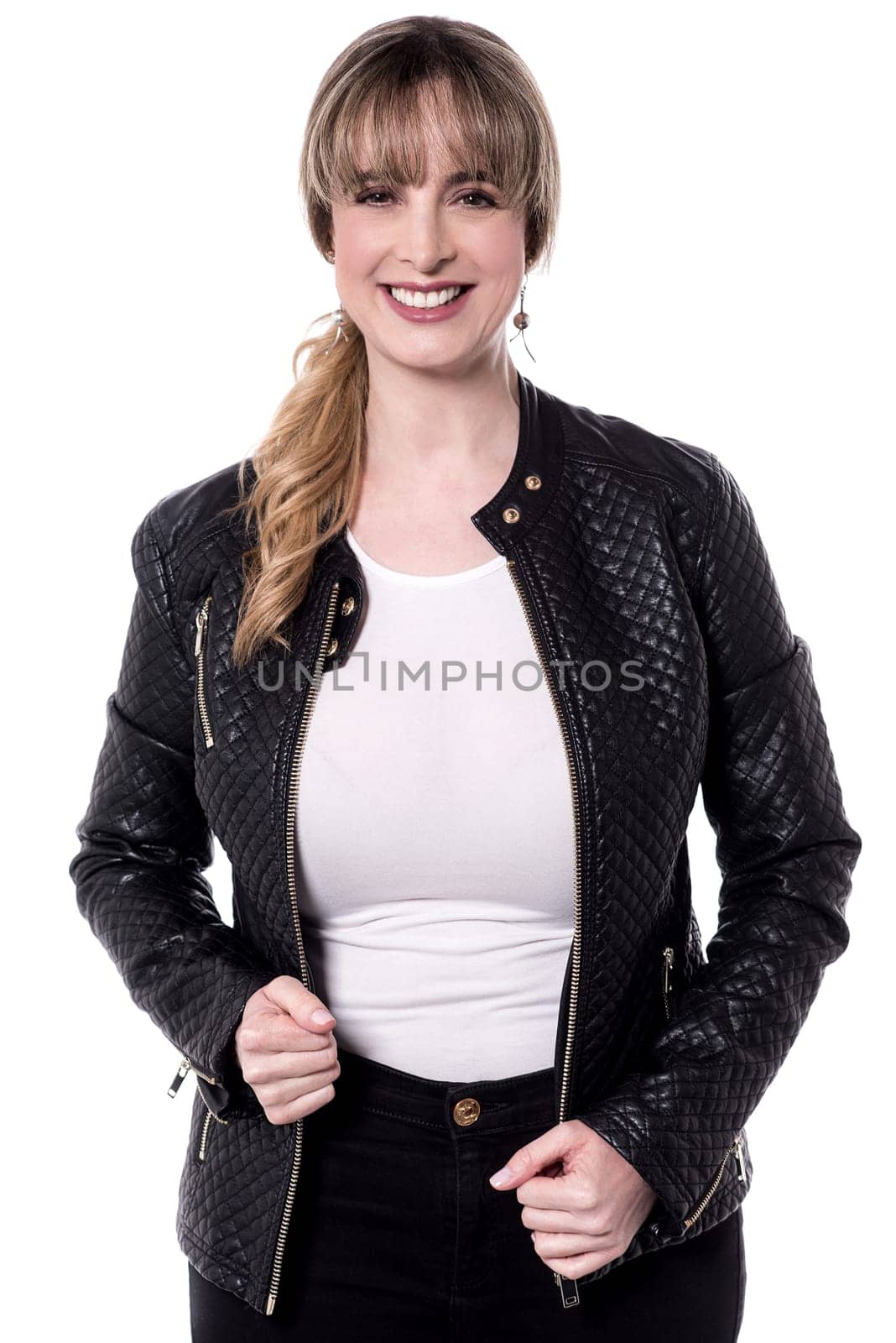 Middle aged woman posing to camera wearing leather jacket