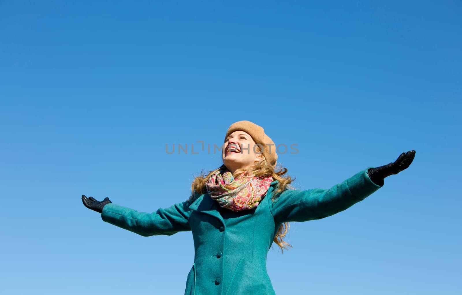 blond casual woman happy outdoors with blue sky