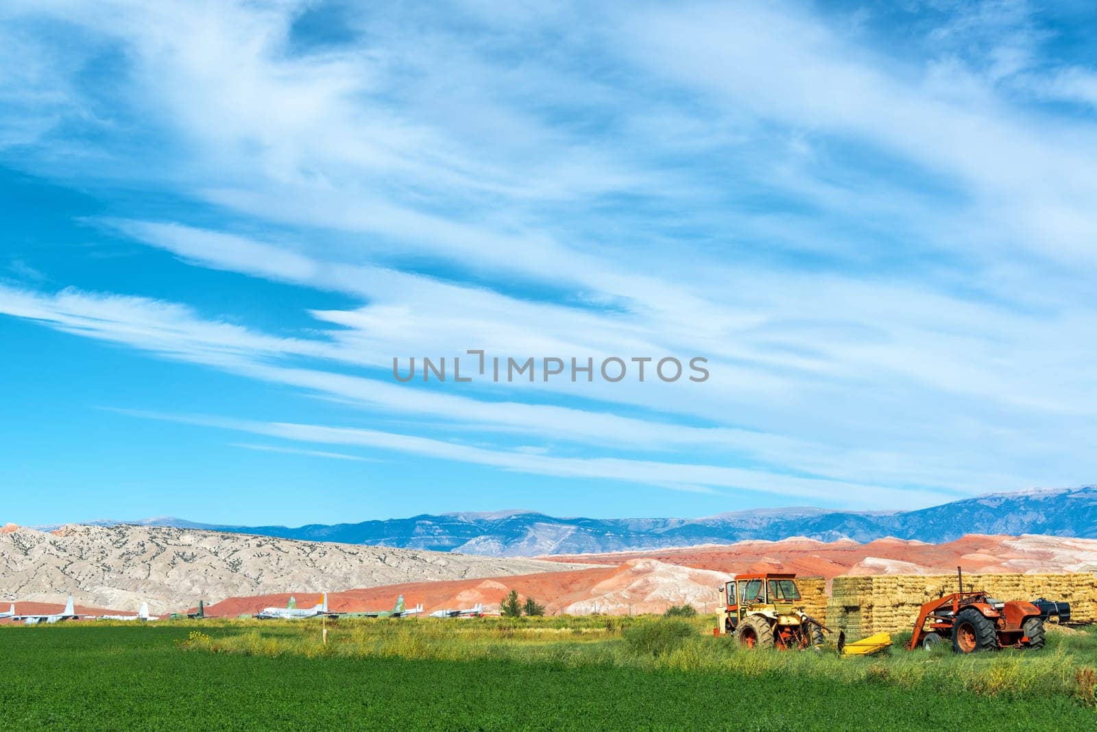 Landscape featuring tractors and an airplane boneyard in Greybull, Wyoming